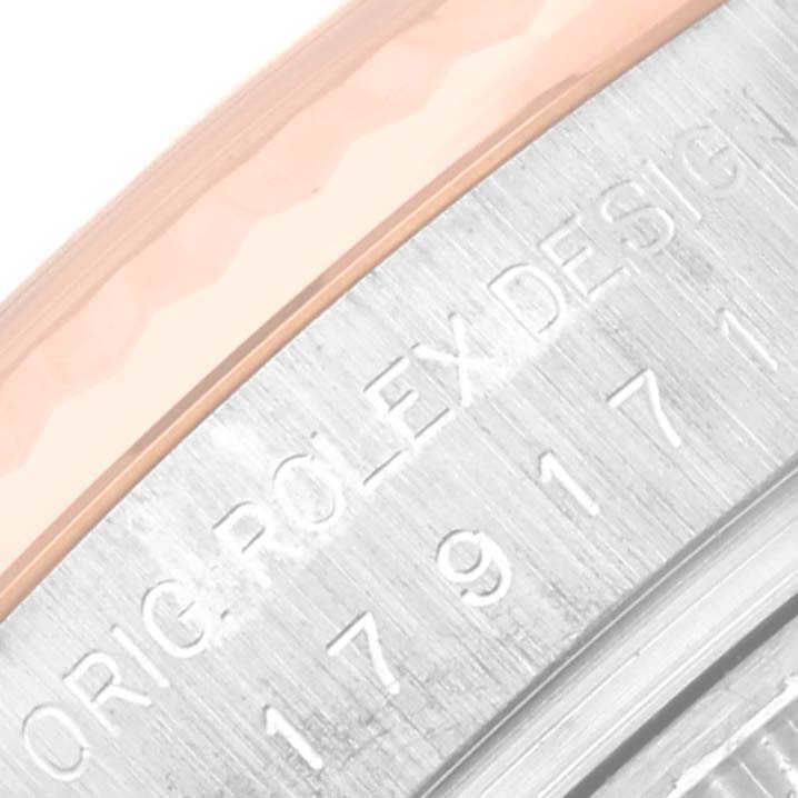 This is a close-up angle showing the branded engraving and bezel of the Rolex Datejust 179171NR Women's Steel and Gold (two tone) Mother of Pearl Dial 179171NR Women's Steel and Gold (two tone) Mother of Pearl Dial watch.