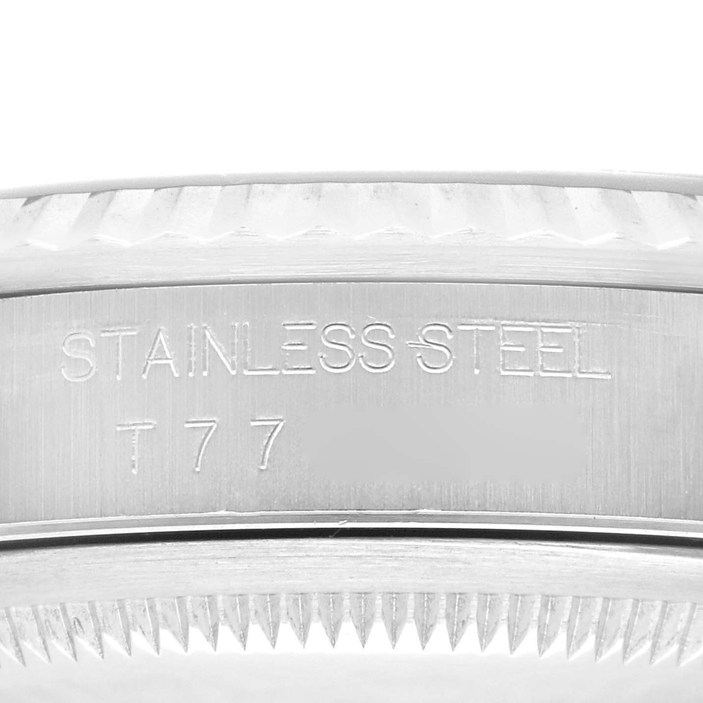 This is a close-up of the case side, showing 'STAINLESS STEEL' and part number engravings on the Rolex Datejust 16234G Men's Stainless Steel Black Dial 16234G Men's Stainless Steel Black Dial model.