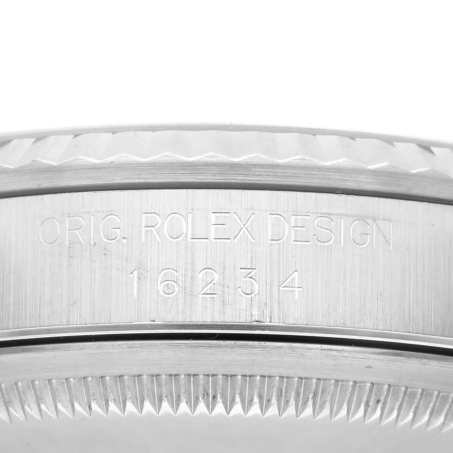 The image shows a close-up of the side engraving and bezel of a Rolex Datejust 16234G Men's Stainless Steel Black Dial 16234G Men's Stainless Steel Black Dial, displaying "ORIG. ROLEX DESIGN 16234".