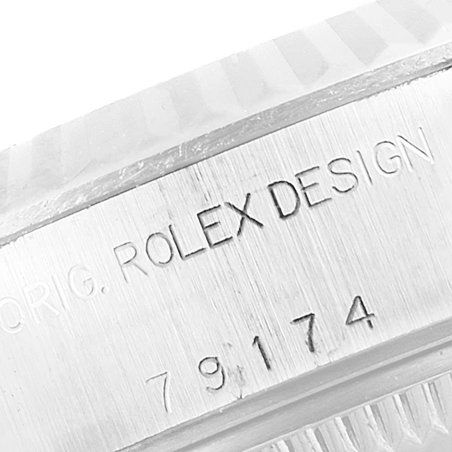 The image shows a close-up of the engraved serial number and "Rolex Design" text on the side of a Rolex Datejust 79174 Women's Stainless Steel Silver Dial 79174 Women's Stainless Steel Silver Dial watch case.