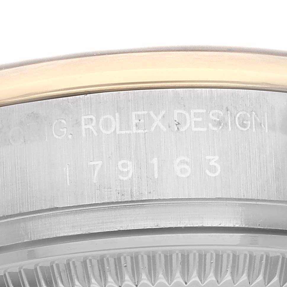 This image shows a close-up of the side of a Rolex Datejust 179163 Women's Steel and Gold (two tone) Blue Dial 179163 Women's Steel and Gold (two tone) Blue Dial watch with engraving details.