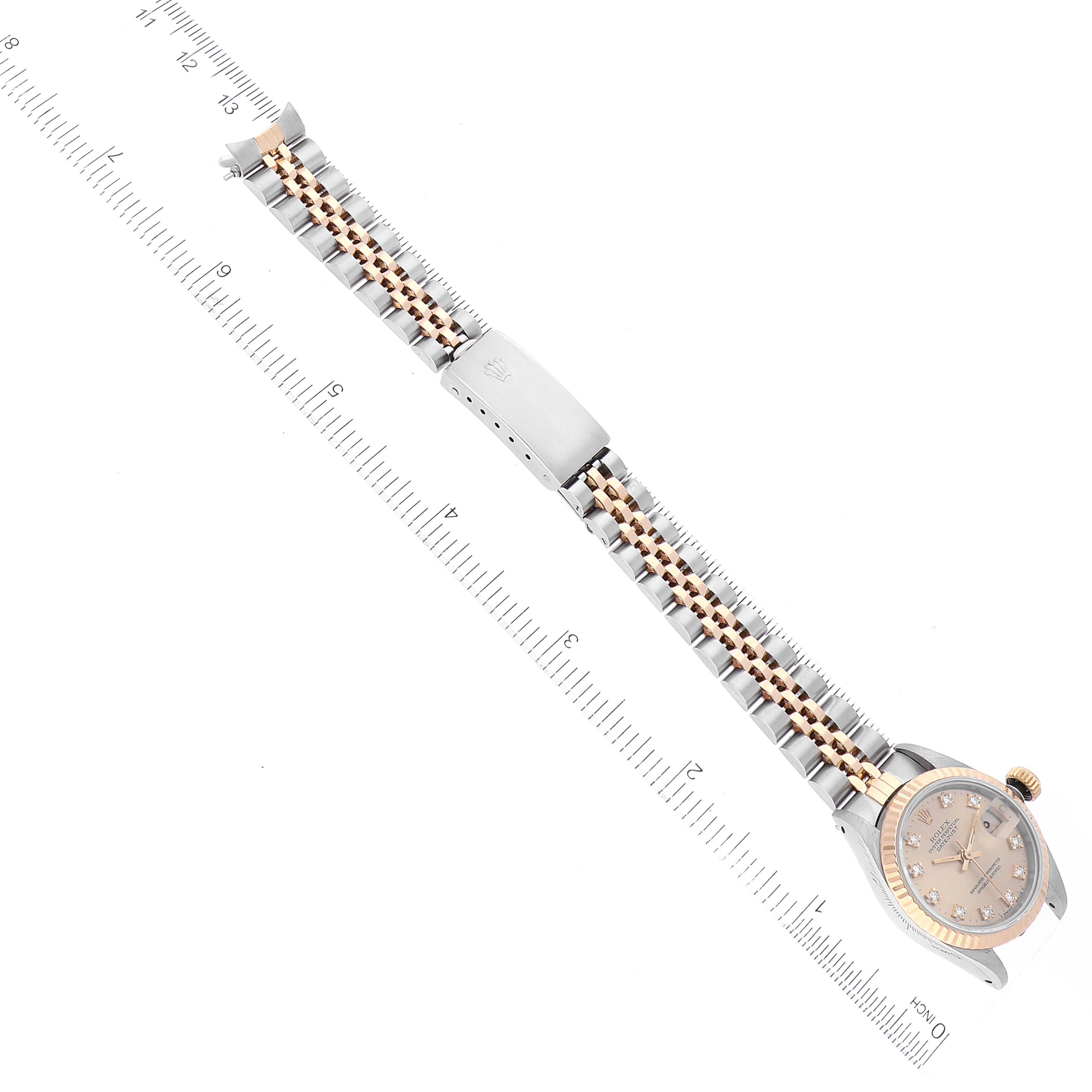 The image shows a top view of a Rolex Datejust 69173 Women's Steel and Gold (two tone) Champagne Dial 69173 Women's Steel and Gold (two tone) Champagne Dial watch, highlighting the dial, bezel, and bracelet extended next to a ruler.