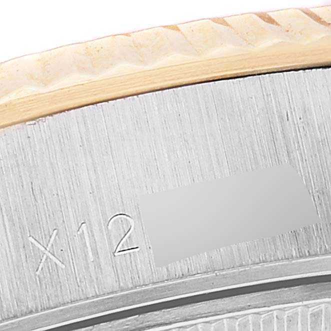 This close-up image shows the fluted bezel and part of the case of a Rolex Datejust 69173 Women's Steel and Gold (two tone) Champagne Dial 69173 Women's Steel and Gold (two tone) Champagne Dial watch.