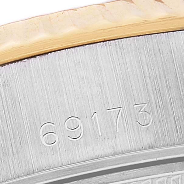 This is a close-up of the serial number and bezel of a Rolex Datejust 69173 Women's Steel and Gold (two tone) Champagne Dial 69173 Women's Steel and Gold (two tone) Champagne Dial watch.