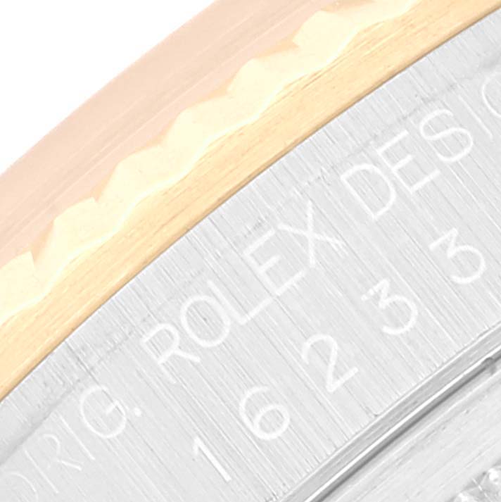 This image shows a close-up view of the side engraving of a Rolex Datejust 16233 Men's Steel and Gold (two tone) Champagne Dial 16233 Men's Steel and Gold (two tone) Champagne Dial watch bezel and edge.