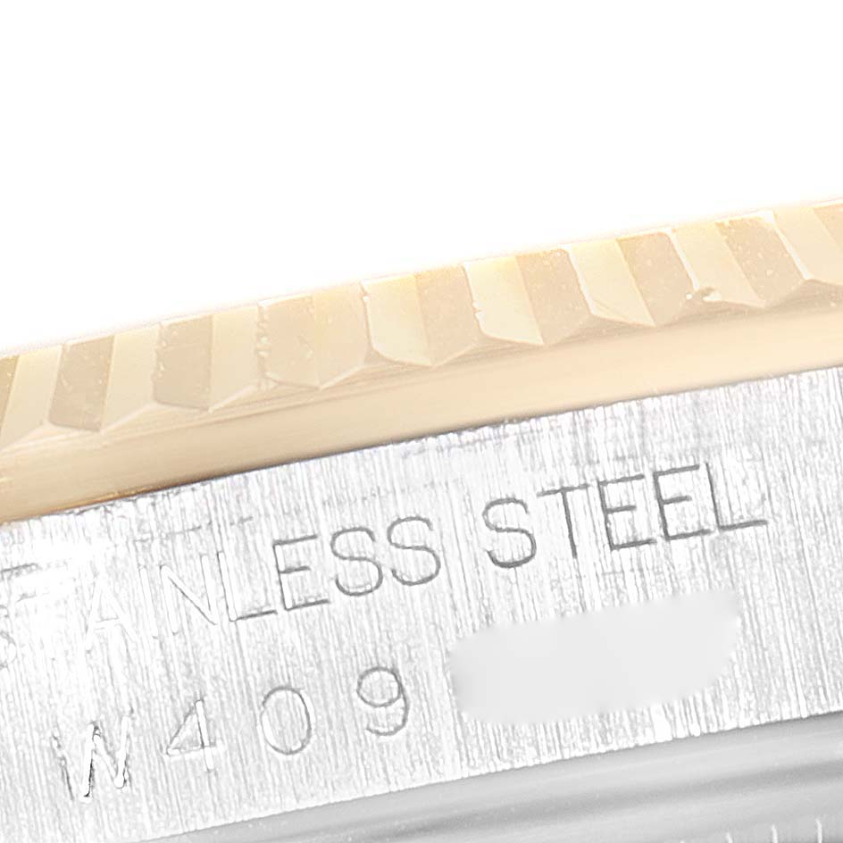 The image shows a close-up of the fluted bezel and case edge with "STAINLESS STEEL" engraving on a Rolex Datejust 16233 Men's Steel and Gold (two tone) Champagne Dial 16233 Men's Steel and Gold (two tone) Champagne Dial.