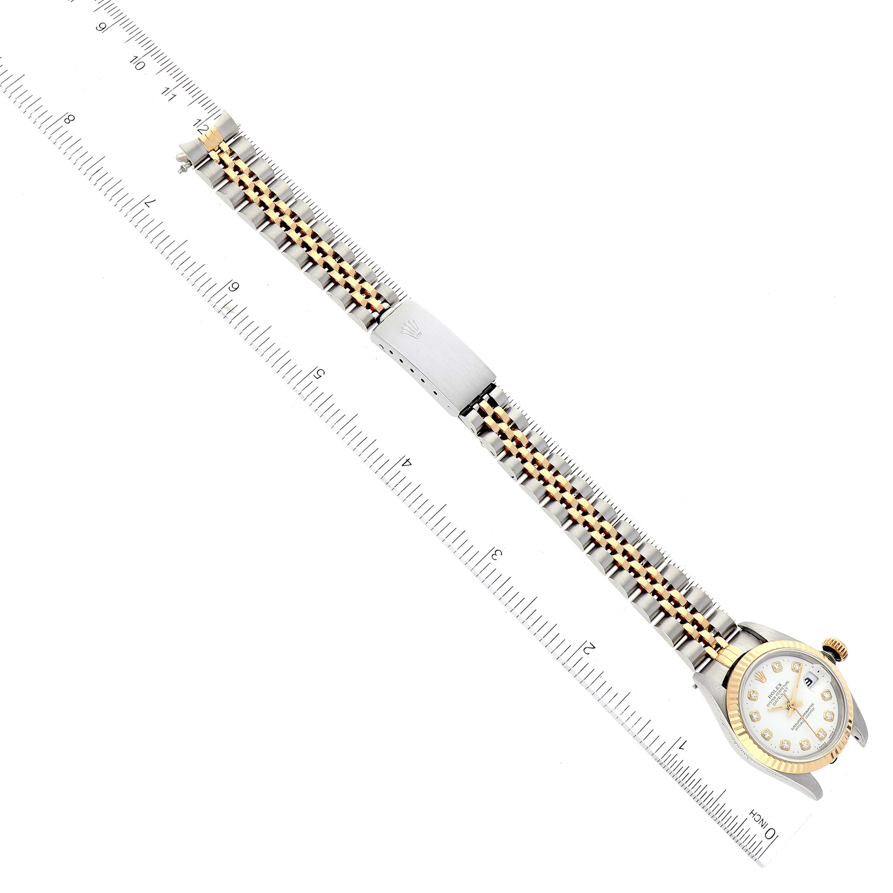 The image shows a top-down view of the Rolex Datejust 69173 Women's Steel and Gold (two tone) White Dial 69173 Women's Steel and Gold (two tone) White Dial watch, displaying its entire band along with a measuring scale.