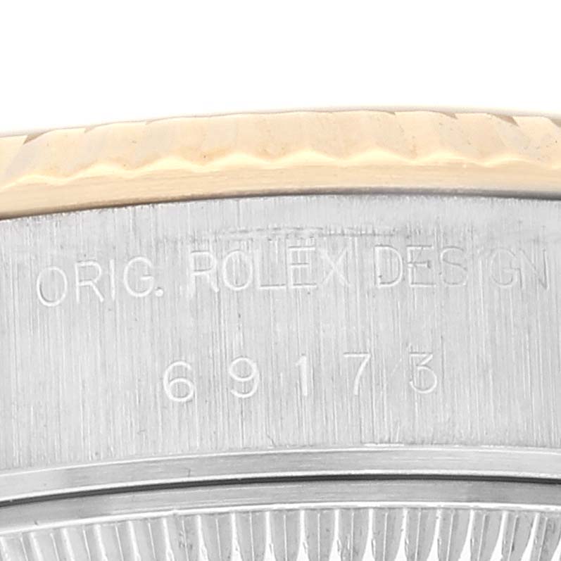 The image shows the side view of a Rolex Datejust 69173 Women's Steel and Gold (two tone) White Dial 69173 Women's Steel and Gold (two tone) White Dial with the engraving "ORIG. ROLEX DESIGN" and the model number 69173.