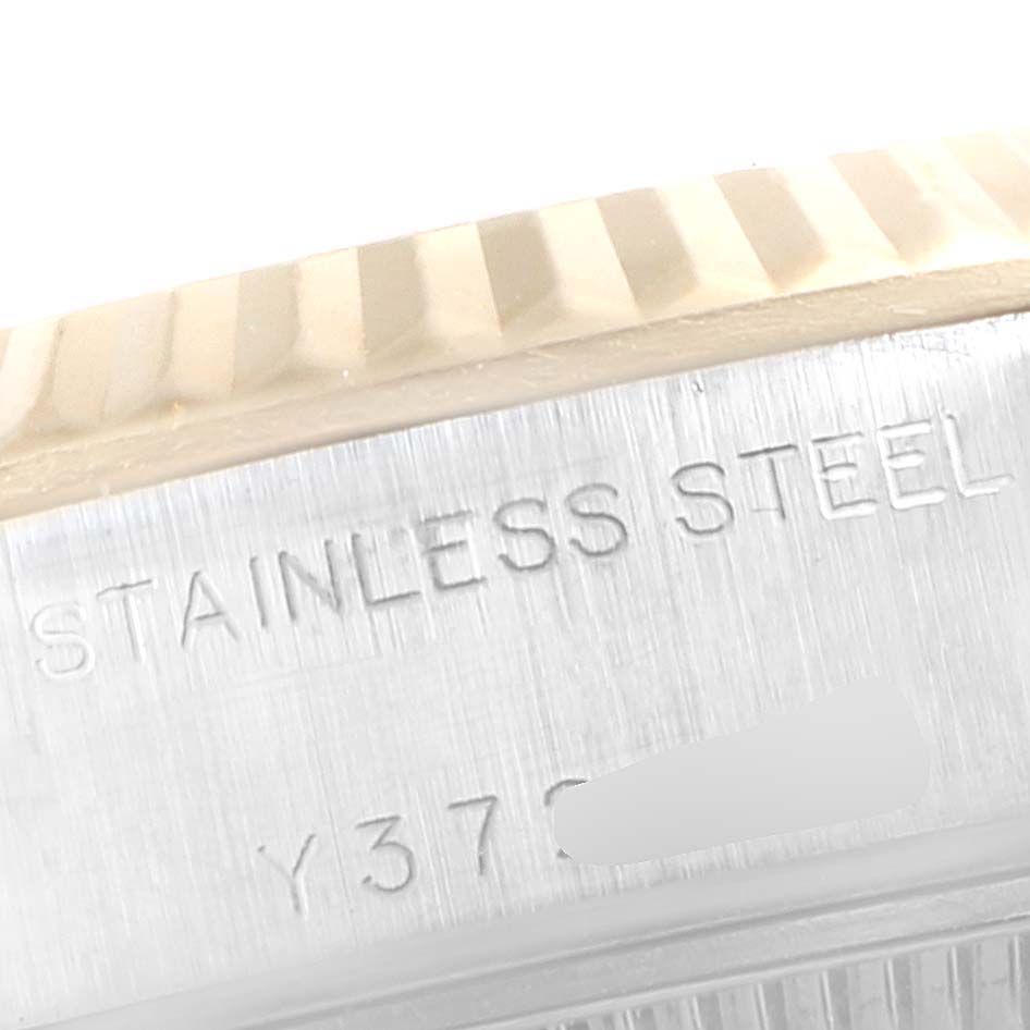 This image shows a macro view of the stainless steel casing and fluted bezel of a Rolex Datejust 79173 Women's Steel and Gold (two tone) Champagne Dial 79173 Women's Steel and Gold (two tone) Champagne Dial watch.