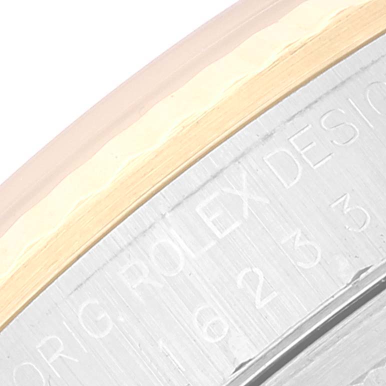 The image shows a close-up of the bezel and part of the case of a Rolex Datejust 16233 Men's Steel and Gold (two tone) White Dial 16233 Men's Steel and Gold (two tone) White Dial watch.