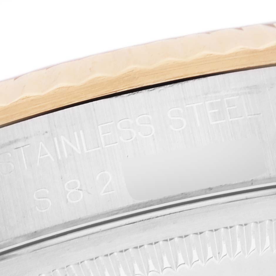 The image shows a close-up angle of the case back and edge of the bezel of a Rolex Datejust 16233 Men's Steel and Gold (two tone) White Dial 16233 Men's Steel and Gold (two tone) White Dial watch.