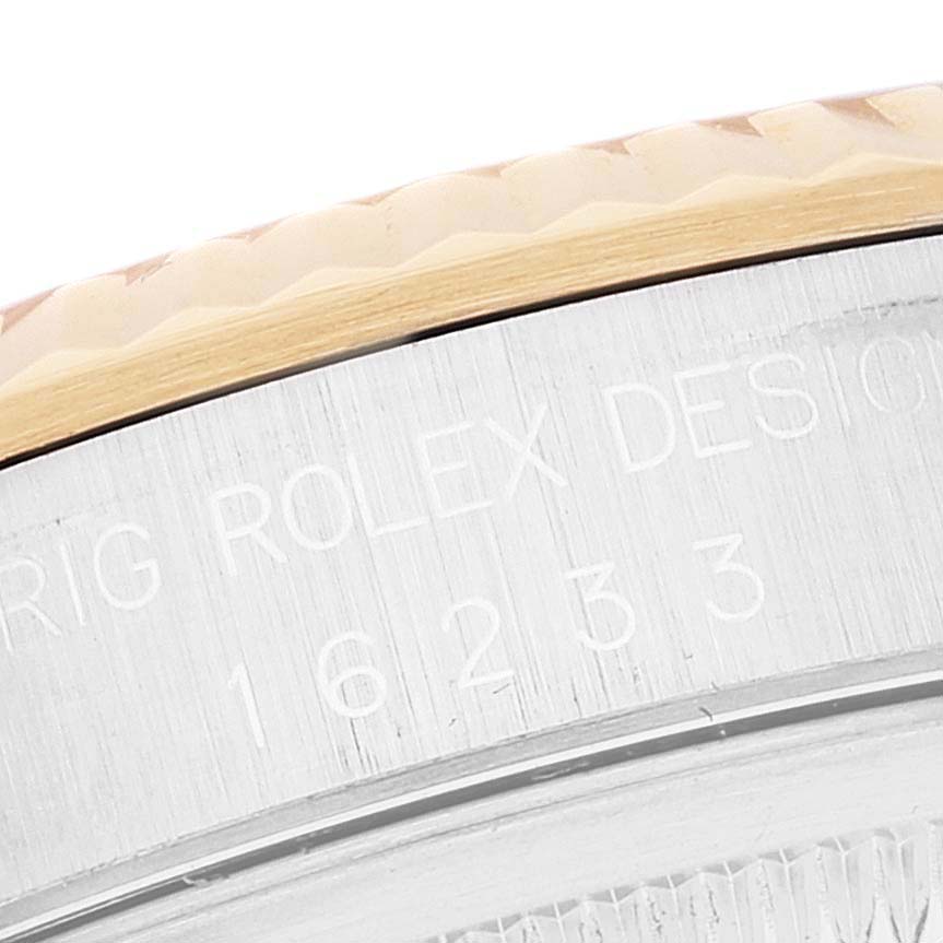 This close-up image shows the engraved details on the edge of the bezel of a Rolex Datejust 16233 Men's Steel and Gold (two tone) White Dial 16233 Men's Steel and Gold (two tone) White Dial watch.
