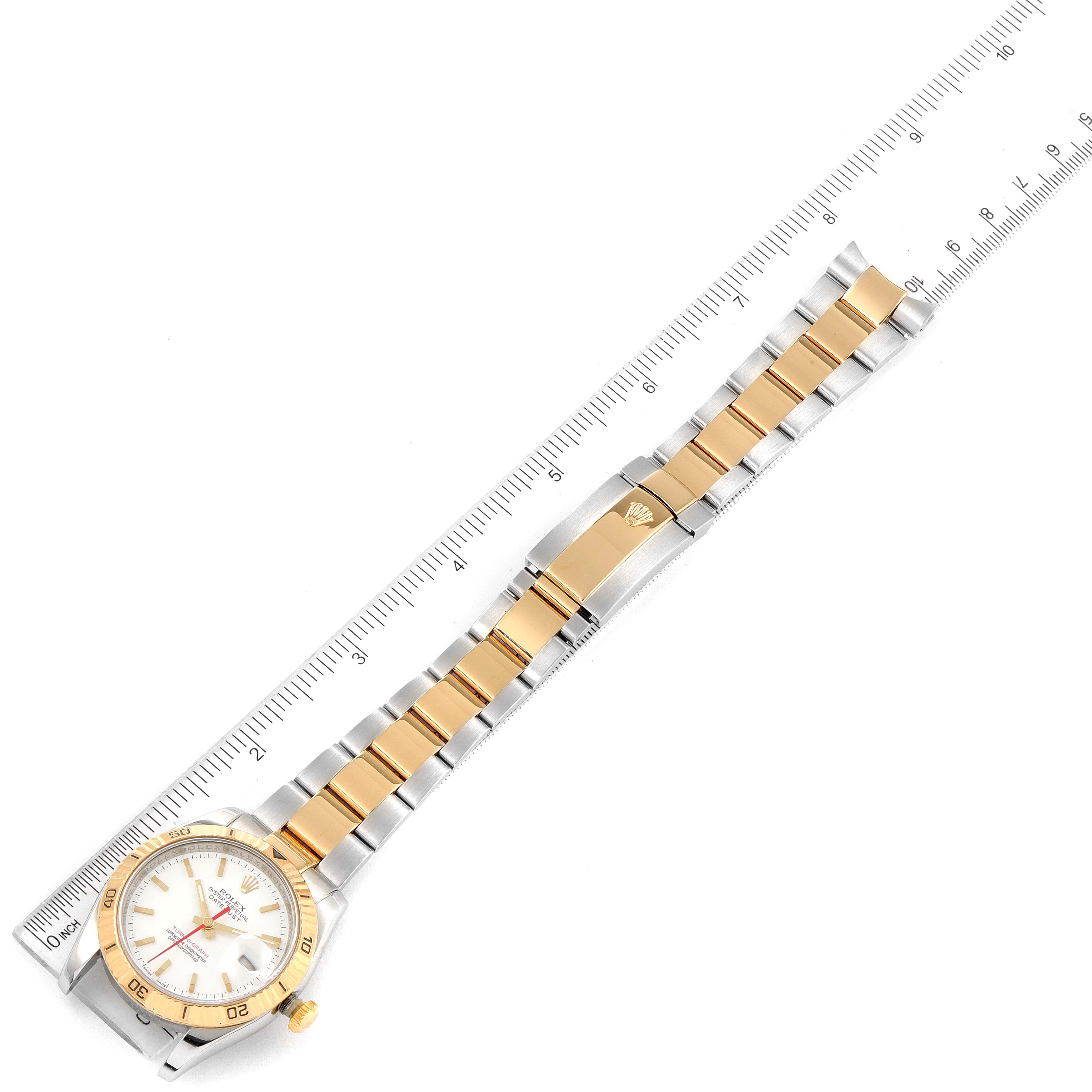 The image shows an overhead view of the Rolex Turn-o-Graph 116263 Men
s Steel and Gold (two tone) White Dial 116263 Men
s Steel and Gold (two tone) White Dial watch, displaying its golden bezel, face, and two-tone bracelet alongside a ruler.