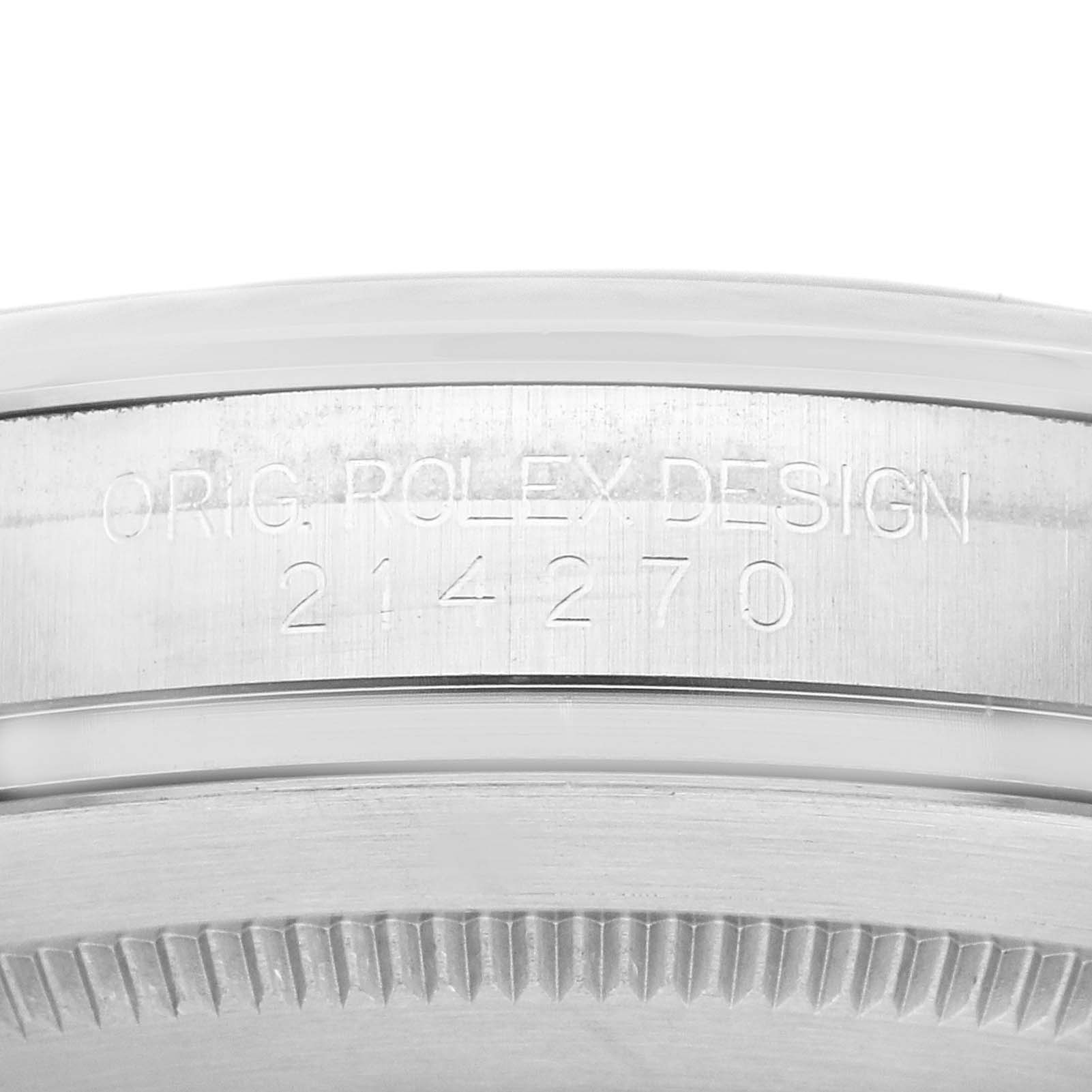 The image shows a close-up of the side of the Rolex Explorer 214270 Men
s Stainless Steel Black Dial 214270 Men
s Stainless Steel Black Dial
s bezel, featuring the engraving "ORIG. ROLEX DESIGN" and the model number "214270."