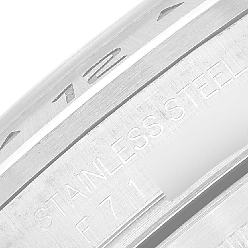 The image shows a close-up angle of the case and bezel of the Rolex Explorer 16570T Men
s Stainless Steel White Dial 16570T Men
s Stainless Steel White Dial watch, highlighting the stainless steel engraving.