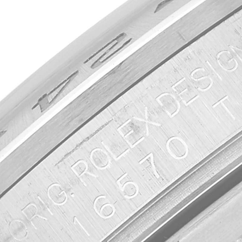 This close-up image shows the engraved inner bezel and case side of a Rolex Explorer 16570T Men
s Stainless Steel White Dial 16570T Men
s Stainless Steel White Dial watch, highlighting the model and brand details.