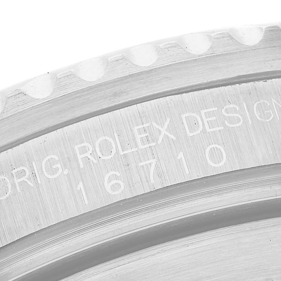 The image shows a close-up angle of the engraving on the case of a Rolex GMT-Master 16710 Men's Stainless Steel Black Dial 16710 Men's Stainless Steel Black Dial model 16710.