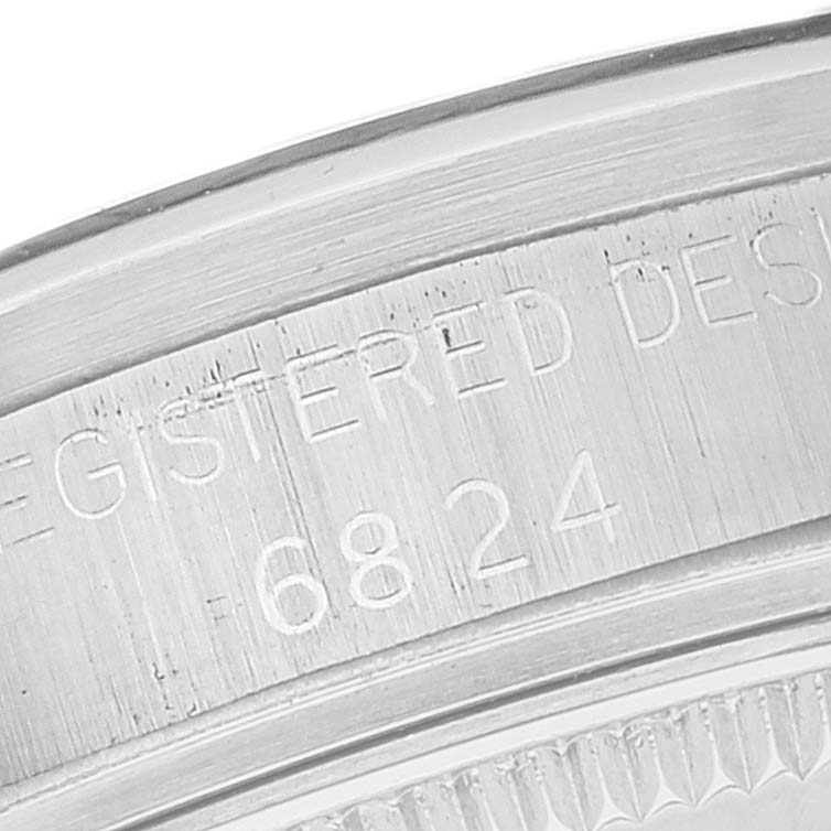 The image shows a close-up of the case back of a Mid-Size Rolex watch, highlighting the engravings.