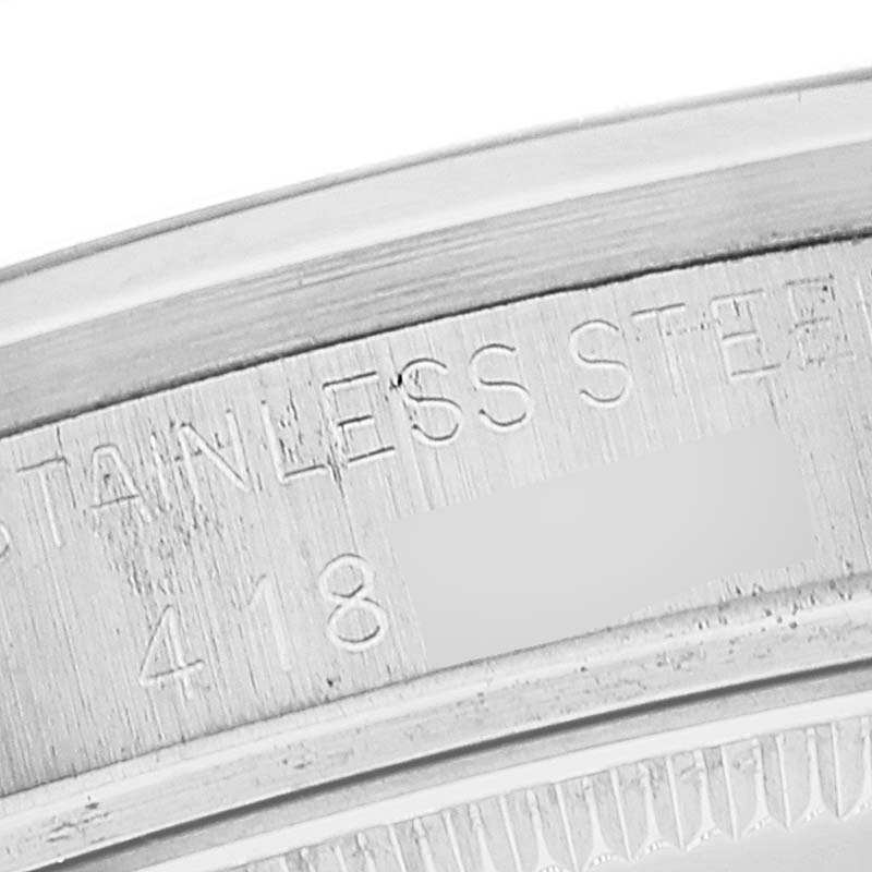 This close-up image of the Rolex Mid-Size 6824 Women's Stainless Steel Grey Dial 6824 Women's Stainless Steel Grey Dial model shows the stainless steel case with engraved text.