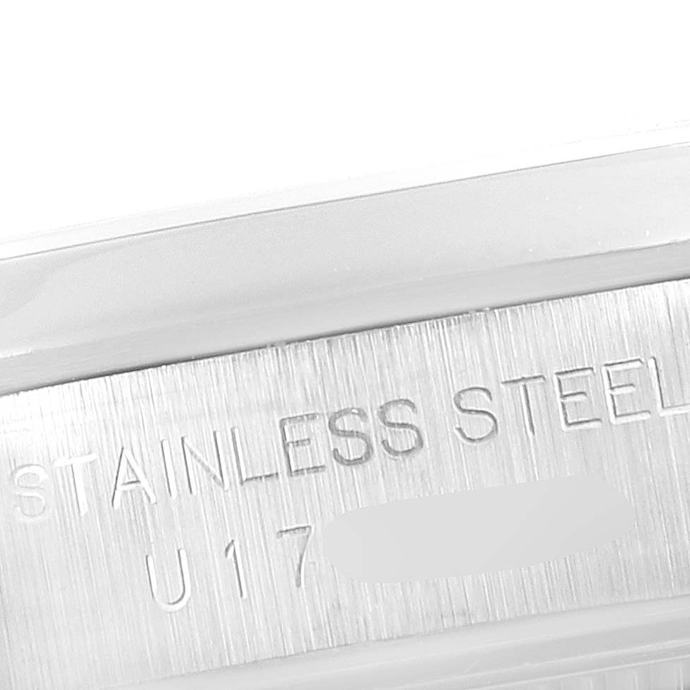 The image shows a close-up of the engraved "STAINLESS STEEL" text on the case side of a Rolex Oyster Perpetual 67180 Women's Stainless Steel Pink Dial 67180 Women's Stainless Steel Pink Dial watch.