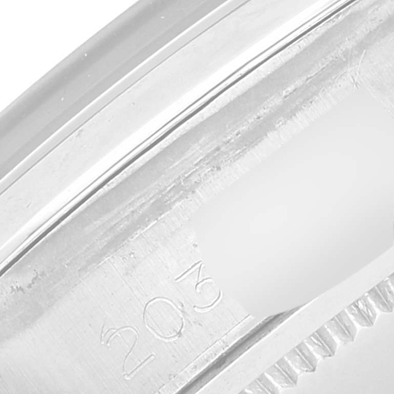 The image shows a close-up of a partial serial number and bezel of a Rolex Vintage Collection 6694 Men's Stainless Steel Black Dial 6694 Men's Stainless Steel Black Dial watch.