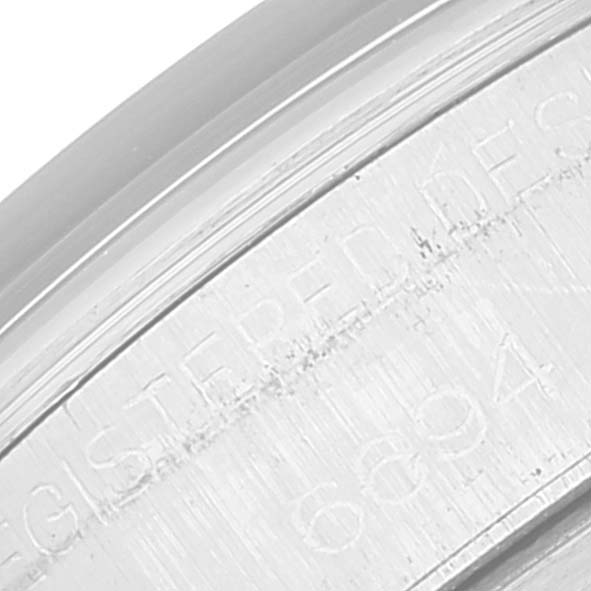 This image shows a close-up of the engravings on the case edge of a Rolex Vintage Collection 6694 Men's Stainless Steel Blue Dial 6694 Men's Stainless Steel Blue Dial watch.