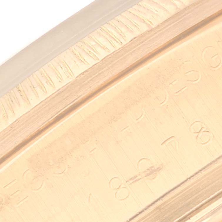 This close-up image shows the engraved side details and fluted bezel of a Rolex President 18078 Men
s Yellow Gold Silver Dial 18078 Men
s Yellow Gold Silver Dial model watch.