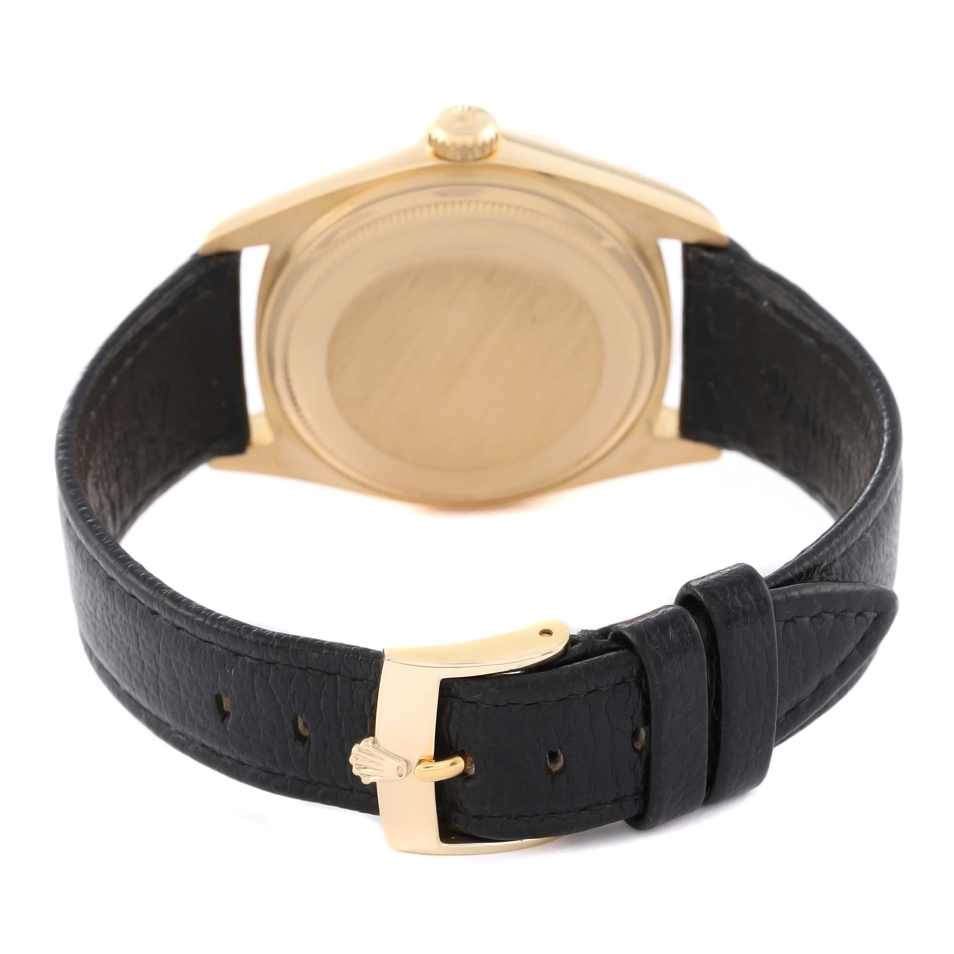 The image shows the back of a Rolex President 18078 Men
s Yellow Gold Silver Dial 18078 Men
s Yellow Gold Silver Dial watch with its leather strap and buckle.