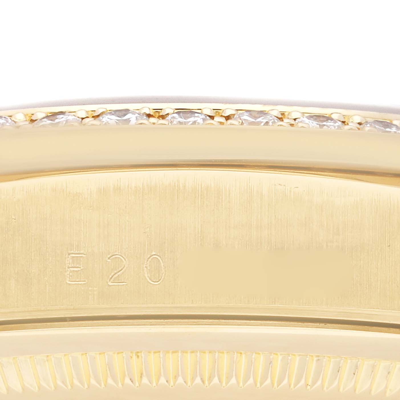 The image shows a close-up of the side of a Rolex President 18348 Men's Yellow Gold Black Dial 18348 Men's Yellow Gold Black Dial model watch, highlighting its bezel and serial number.