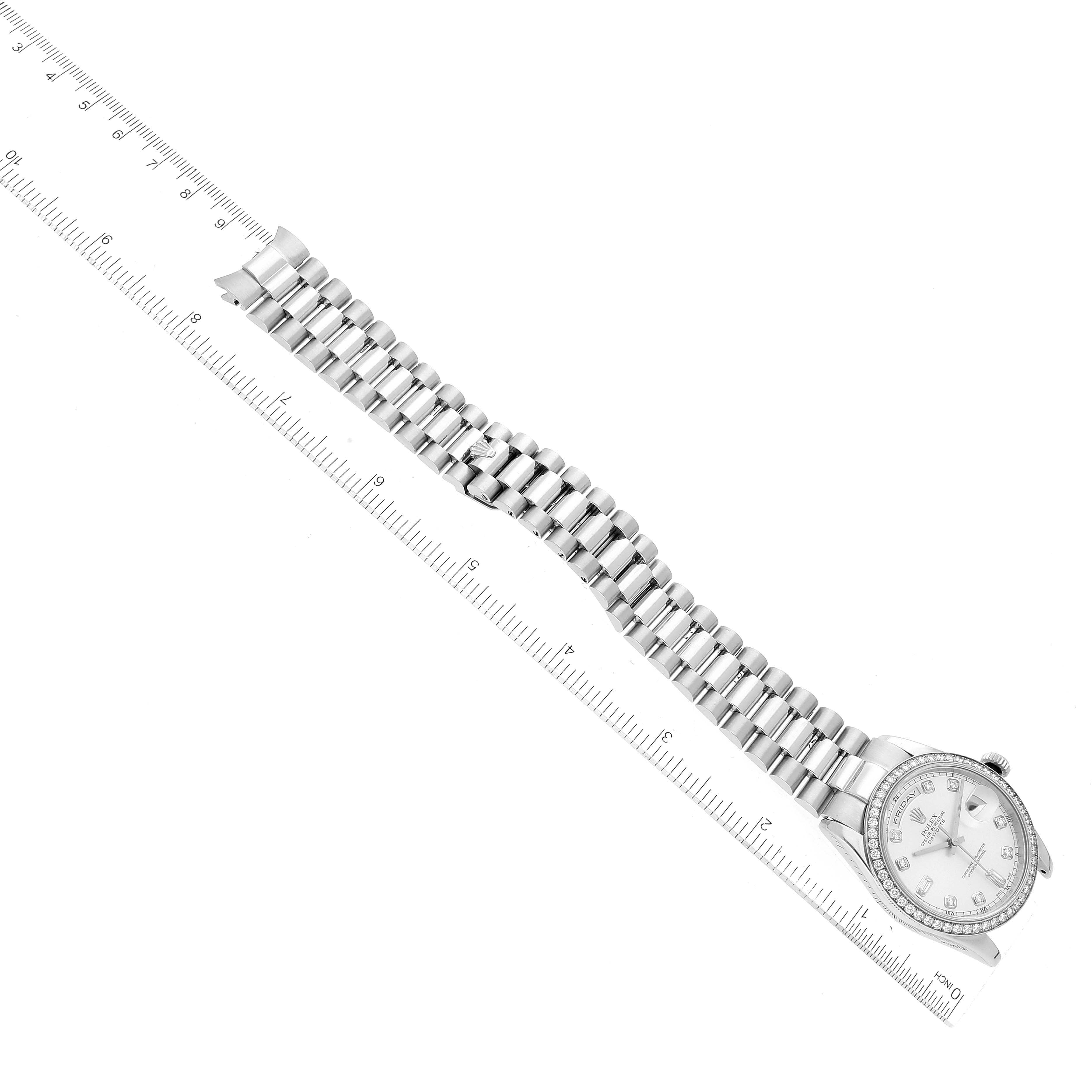 The Rolex President 118346 Men's Platinum Silver Dial 118346 Men's Platinum Silver Dial model is shown from a top-down angle, displaying the watch face, bracelet, and clasp alongside a ruler for scale.