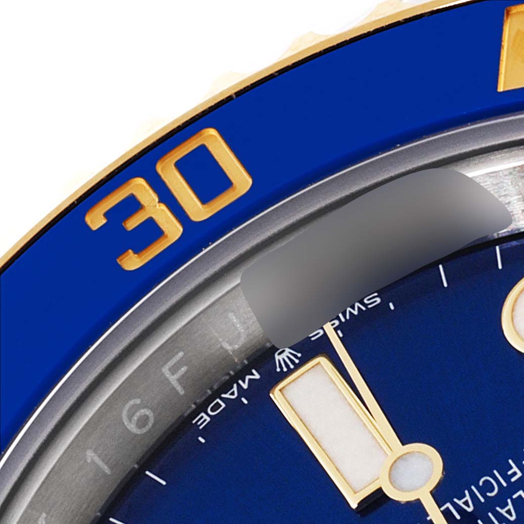 The image shows a close-up of the bezel and dial of a Rolex Submariner 126613 Men's Steel and Gold (two tone) Blue Dial 126613 Men's Steel and Gold (two tone) Blue Dial watch, highlighting the 30-minute marker.