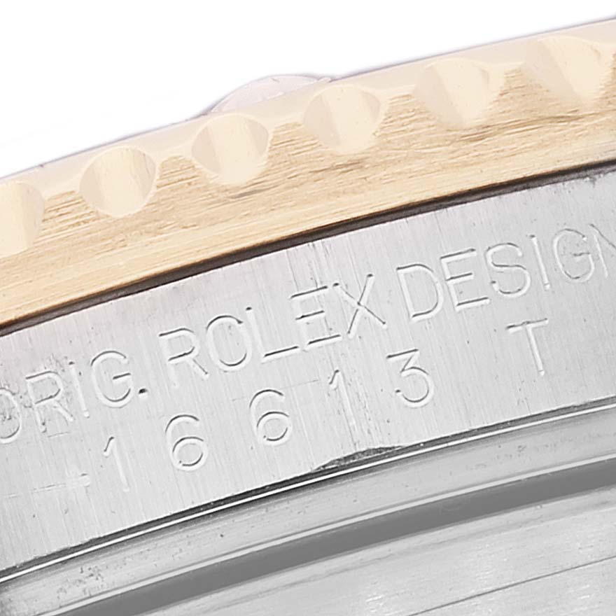 The image shows a close-up of the side of the bezel and case of a Rolex Submariner 16613 Men
s Stainless Steel Blue Dial 16613 Men
s Stainless Steel Blue Dial, highlighting its etched model details.