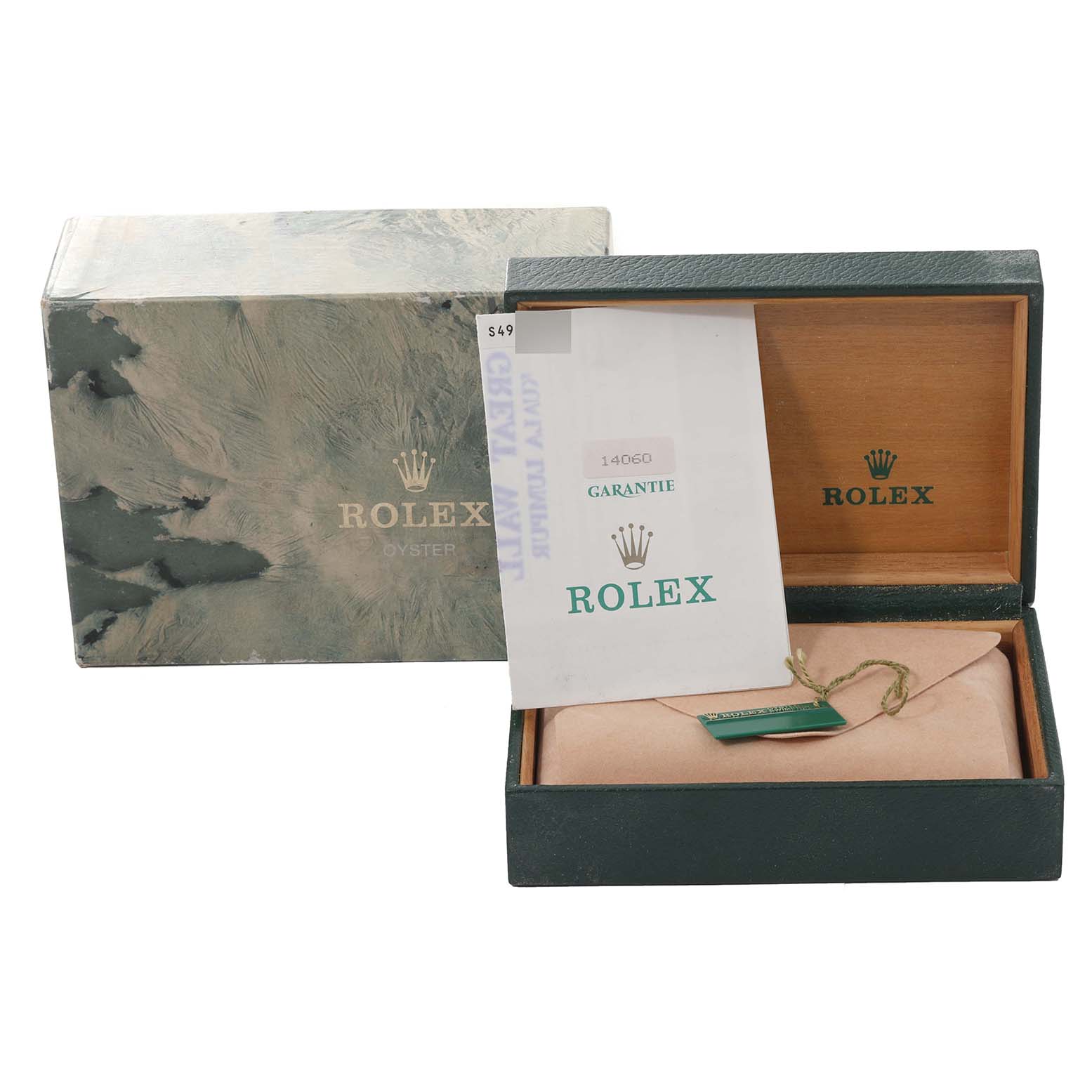 The image shows a Rolex Submariner 14060 Men
s Stainless Steel Black Dial 14060 Men
s Stainless Steel Black Dial
s box, open with a warranty card and tag inside, alongside the original outer packaging.