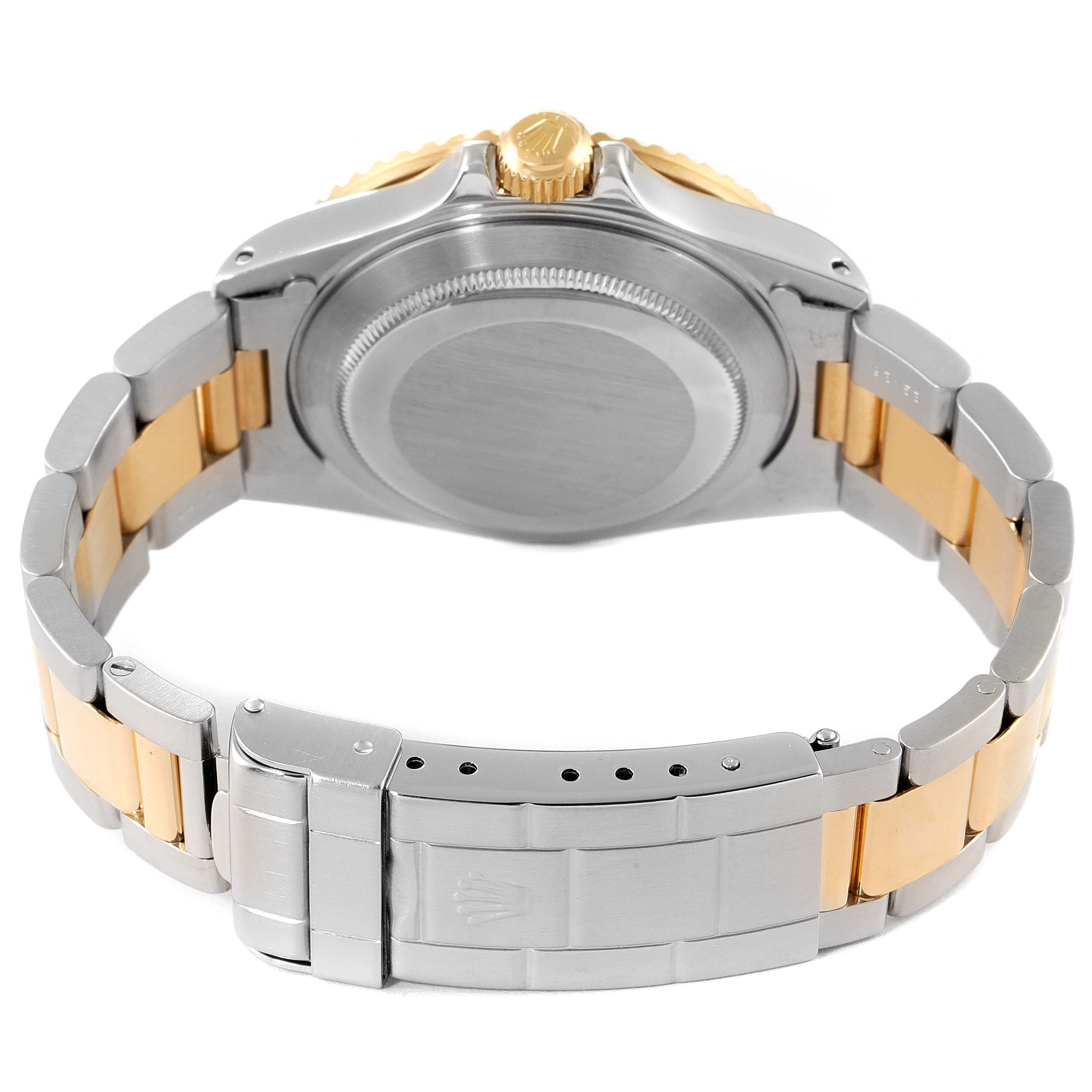 This image shows the back case, crown, and clasp of a Rolex Submariner 16803 Men
s Steel and Gold (two tone) Blue Dial 16803 Men
s Steel and Gold (two tone) Blue Dial watch from a rear angle.