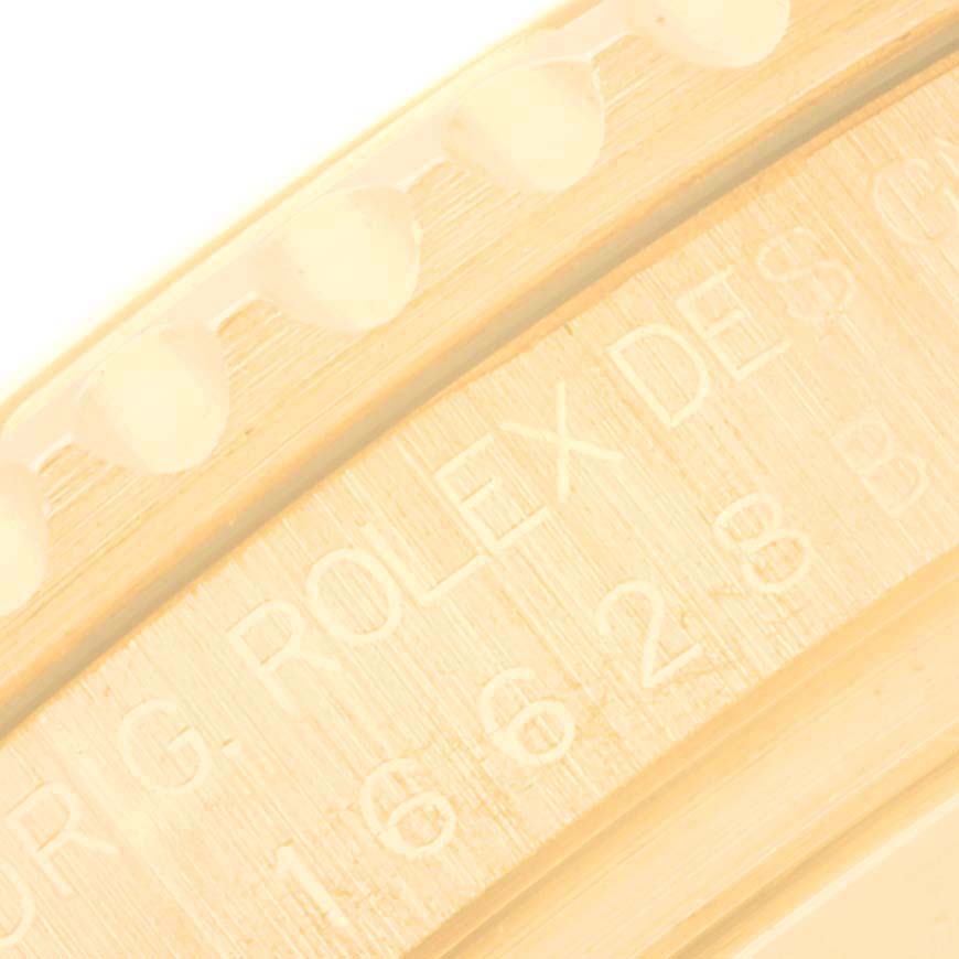 The image shows a close-up of the Rolex Yacht-Master 16628 Men's Yellow Gold White Dial 16628 Men's Yellow Gold White Dial's bezel and part of its inner engraving with the brand and model number.