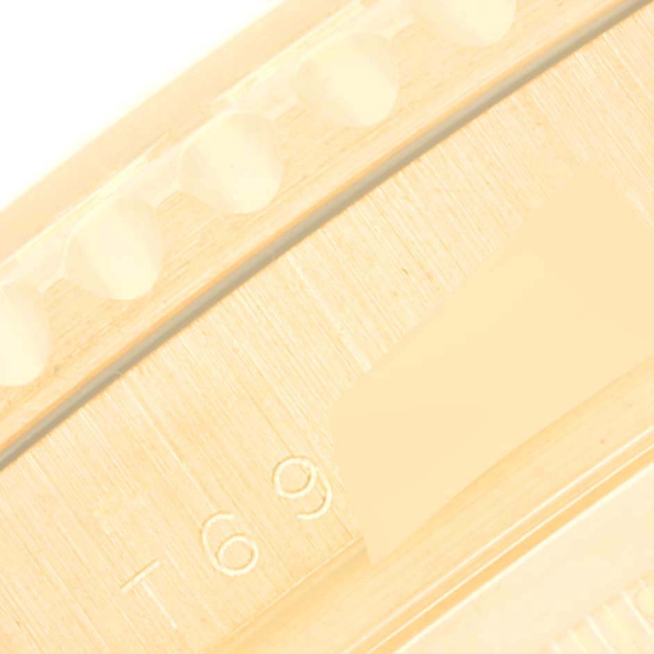 The image shows a close-up of the bezel edge of a Rolex Yacht-Master 16628 Men's Yellow Gold White Dial 16628 Men's Yellow Gold White Dial watch, featuring engraved markings.