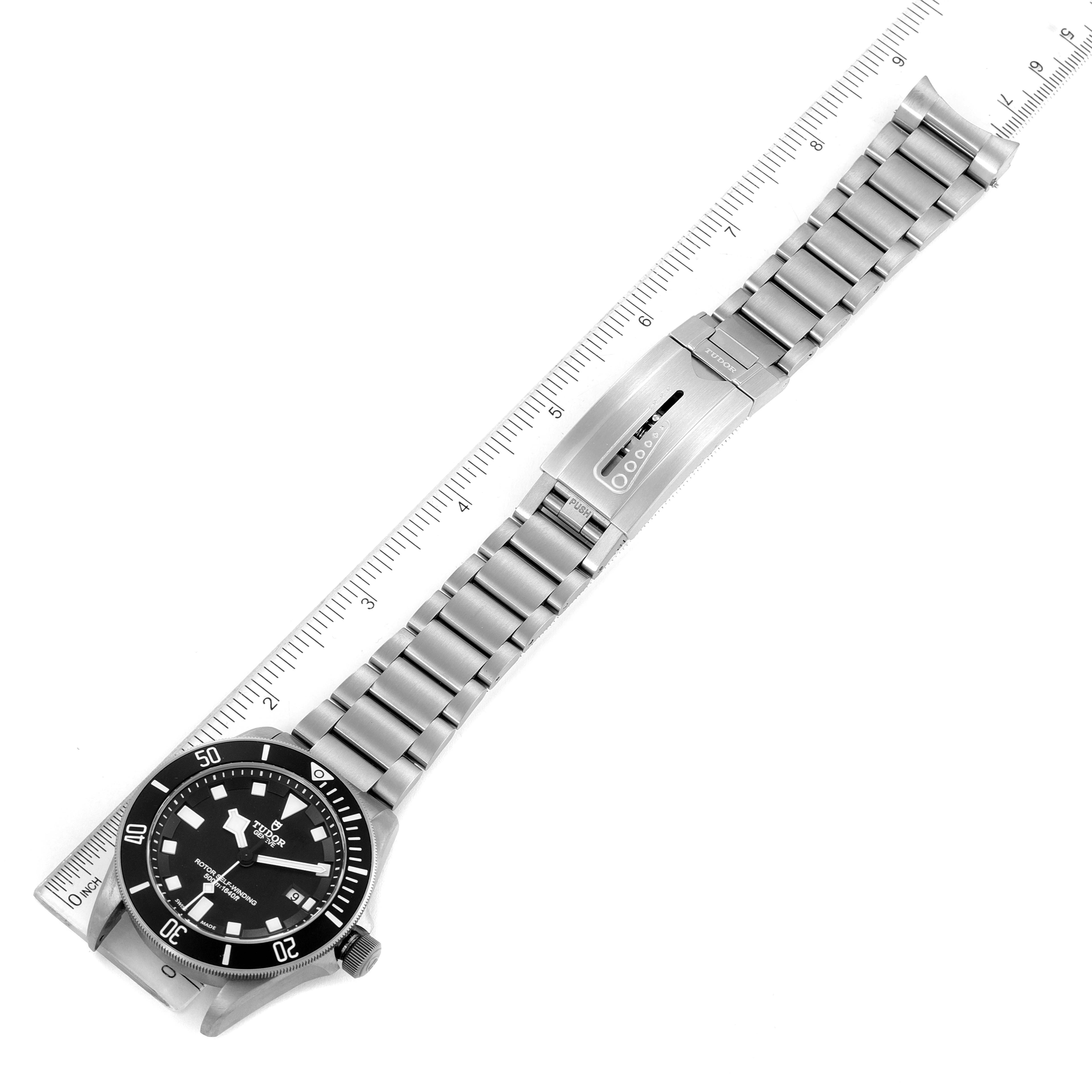 This image shows the Tudor Pelagos 25500TN Men's Titanium Black Dial 25500TN Men's Titanium Black Dial watch laid flat, highlighting the entire bracelet and clasp, with a ruler for scale.