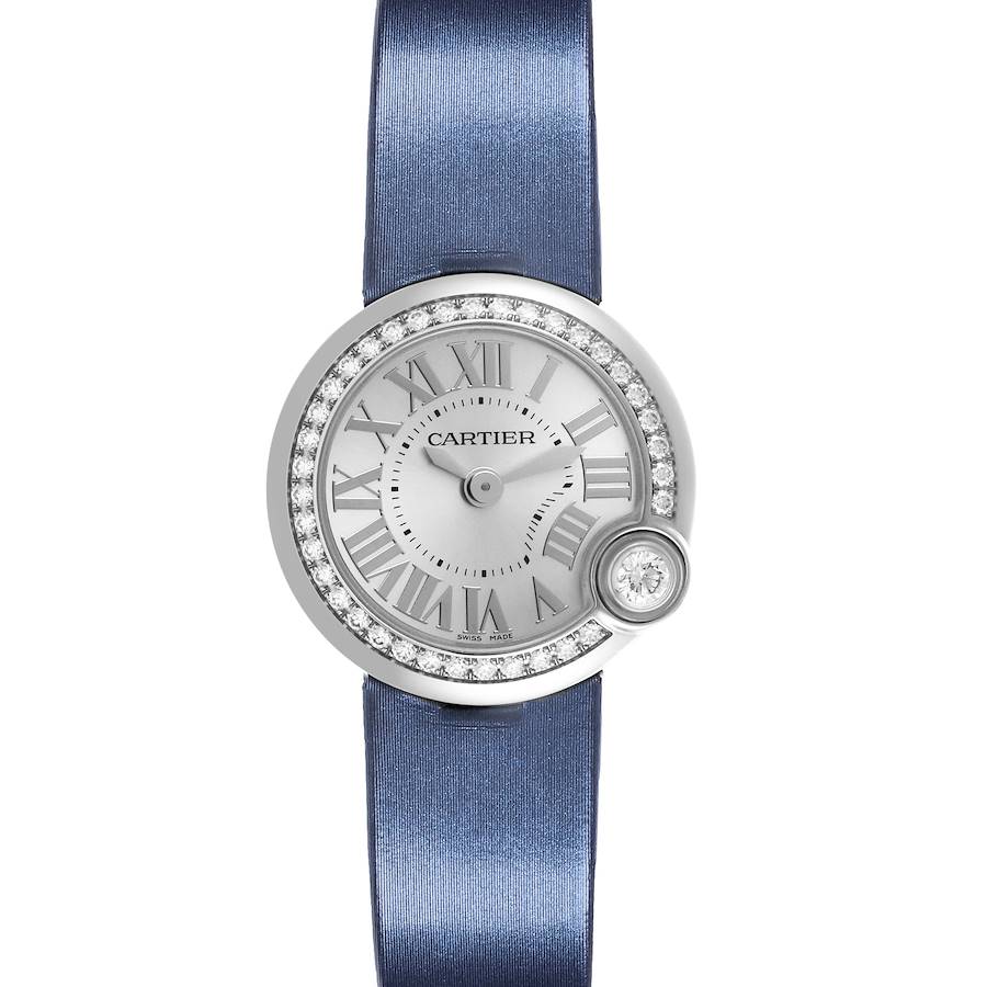 The Cartier Ballon Blanc watch is shown from a top-down angle, highlighting its round face, Roman numerals, diamond bezel, and blue strap.