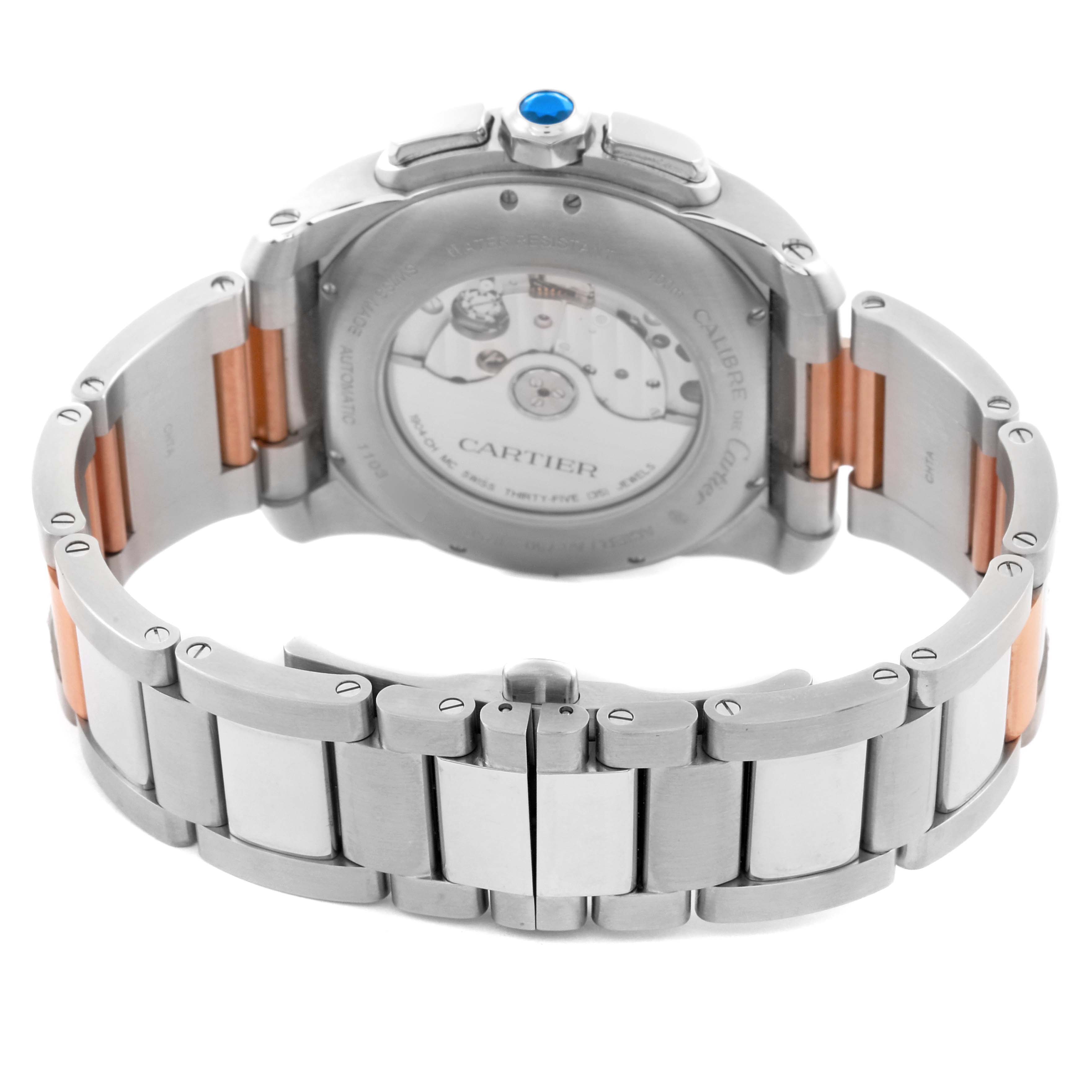 The image shows the back of the Calibre de Cartier watch, highlighting its movement and bracelet detail, including the clasp and links.