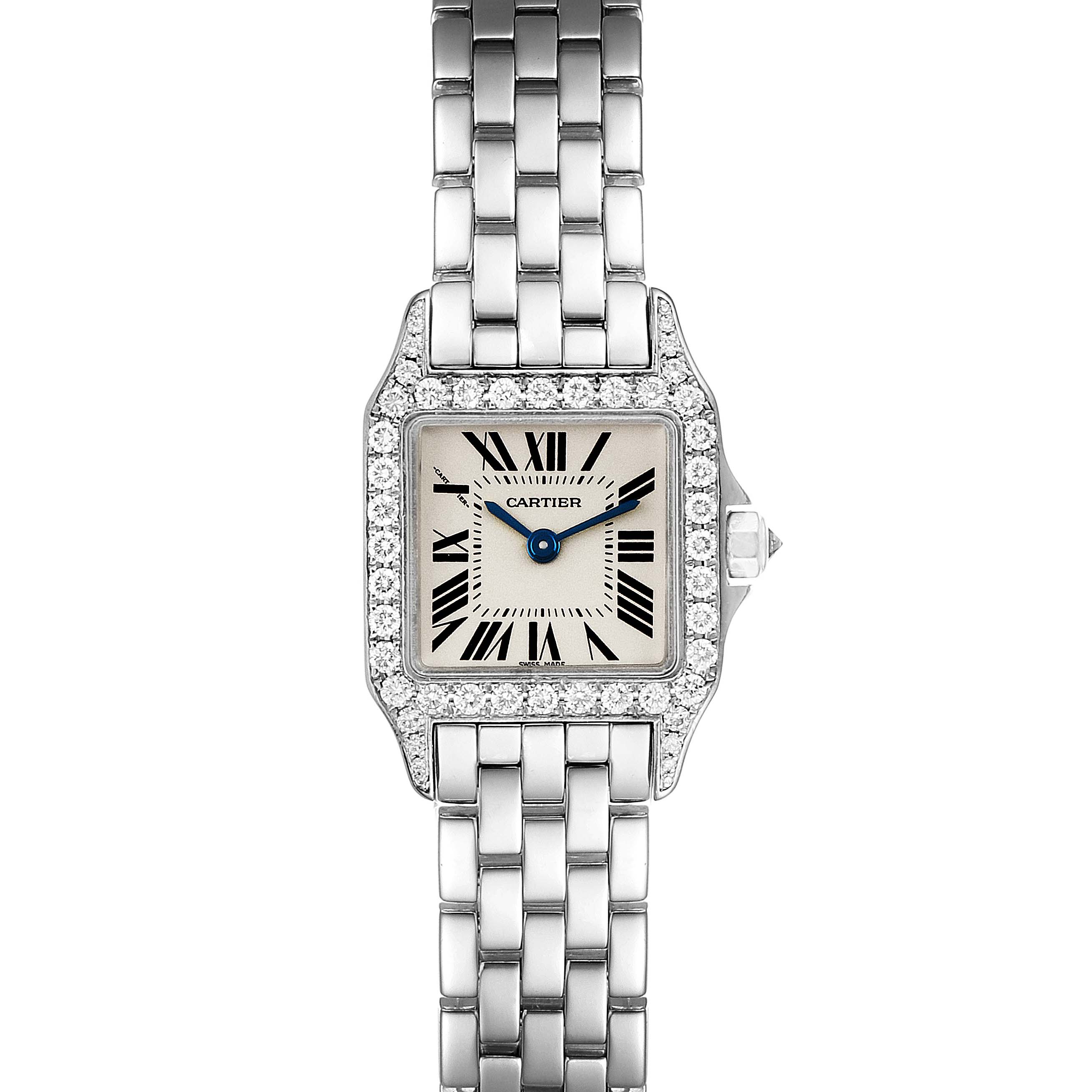 This image shows a Cartier Santos Demoiselle WF9005Y8 Women's White Gold Silver Dial WF9005Y8 Women's White Gold Silver Dial watch from a top-down angle, displaying its face, bezel, and part of the bracelet.