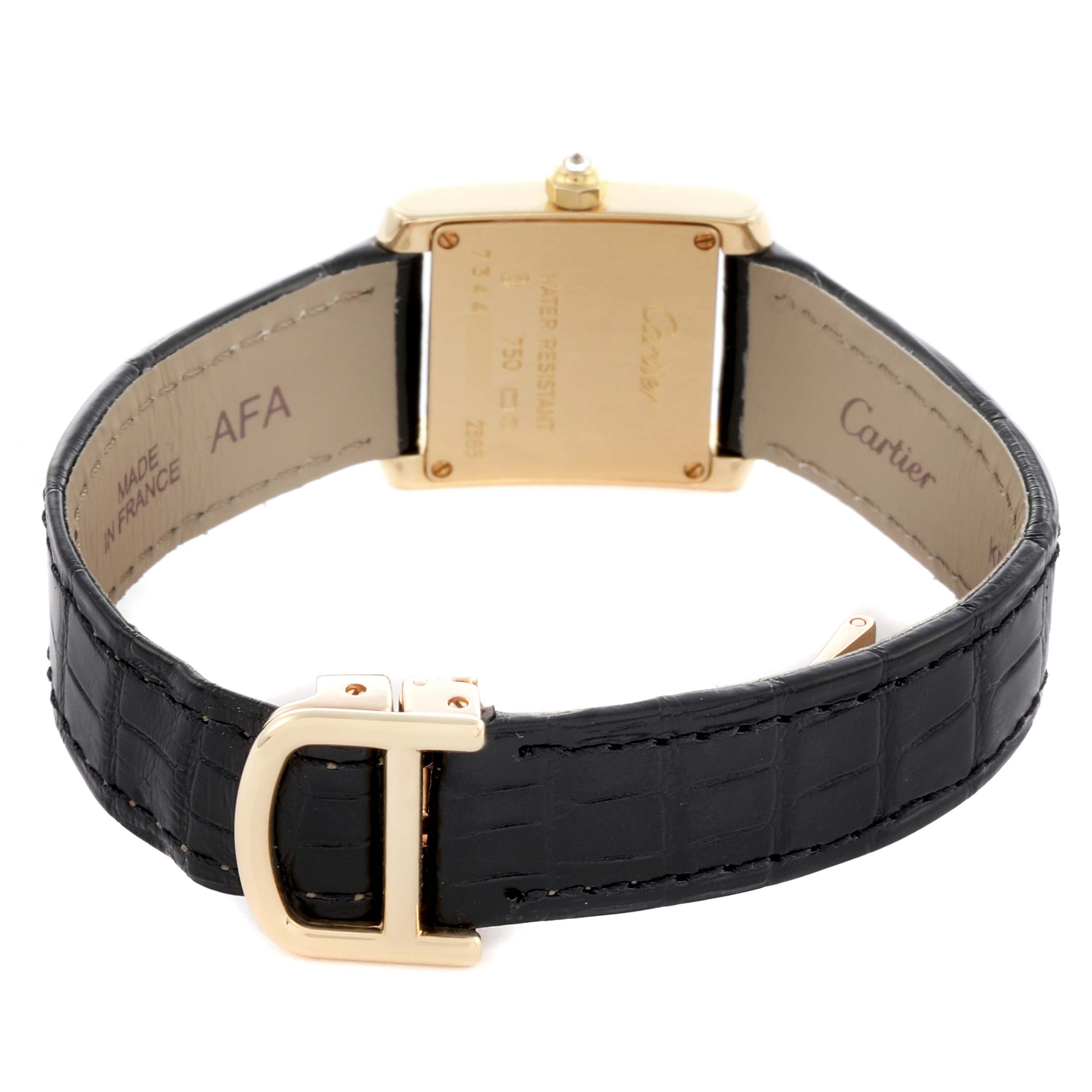 The Cartier Tank Française watch is shown from the back, highlighting the case back, strap, and clasp.