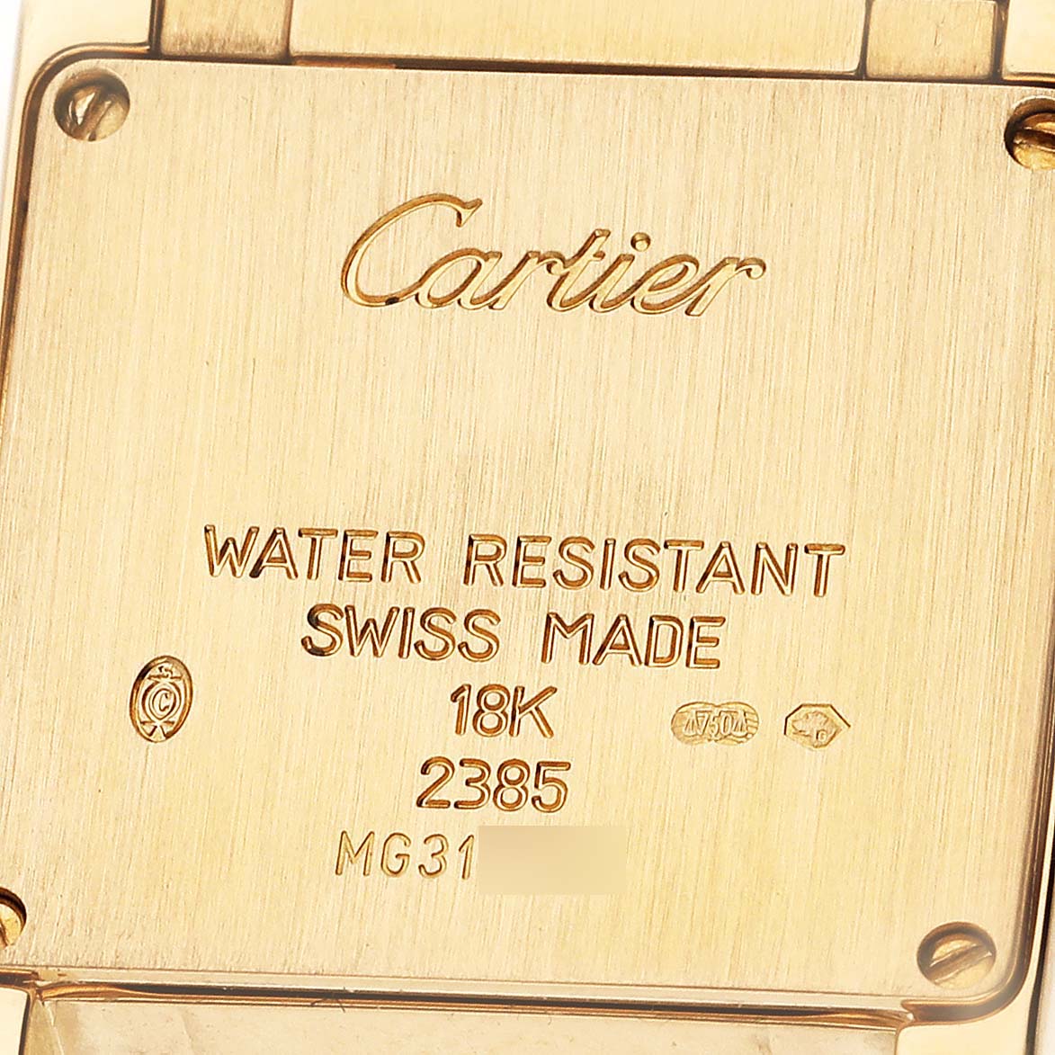 The image shows the back of a Cartier Tank Française watch, highlighting inscriptions and material details.
