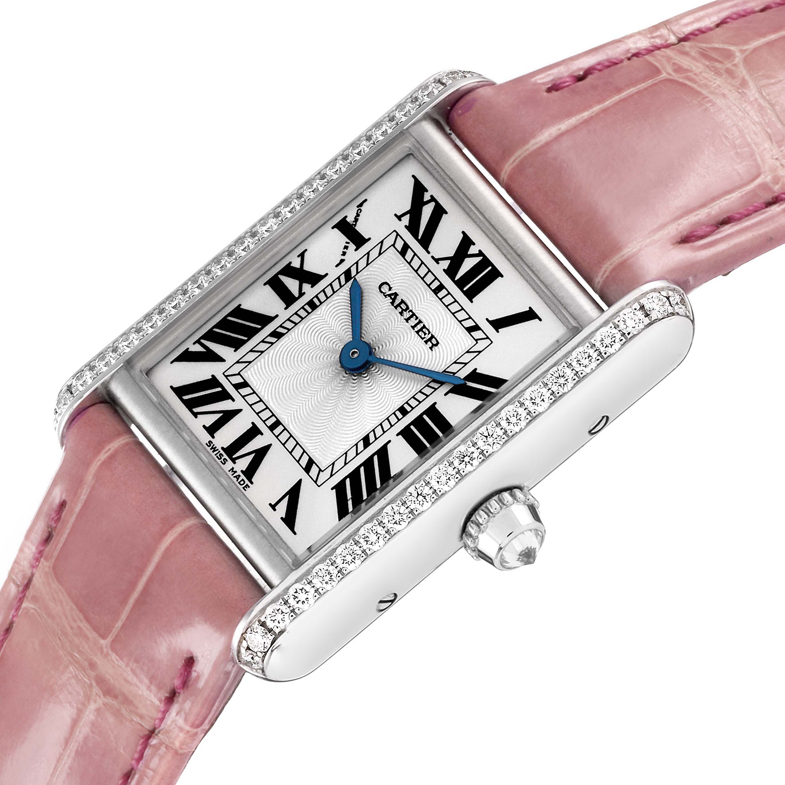 The Cartier Tank Louis WJTA0011 Women's White Gold Silver Dial watch is shown at an angled top view, highlighting its pink strap, diamond-set case, and crown with a sapphire cabochon.