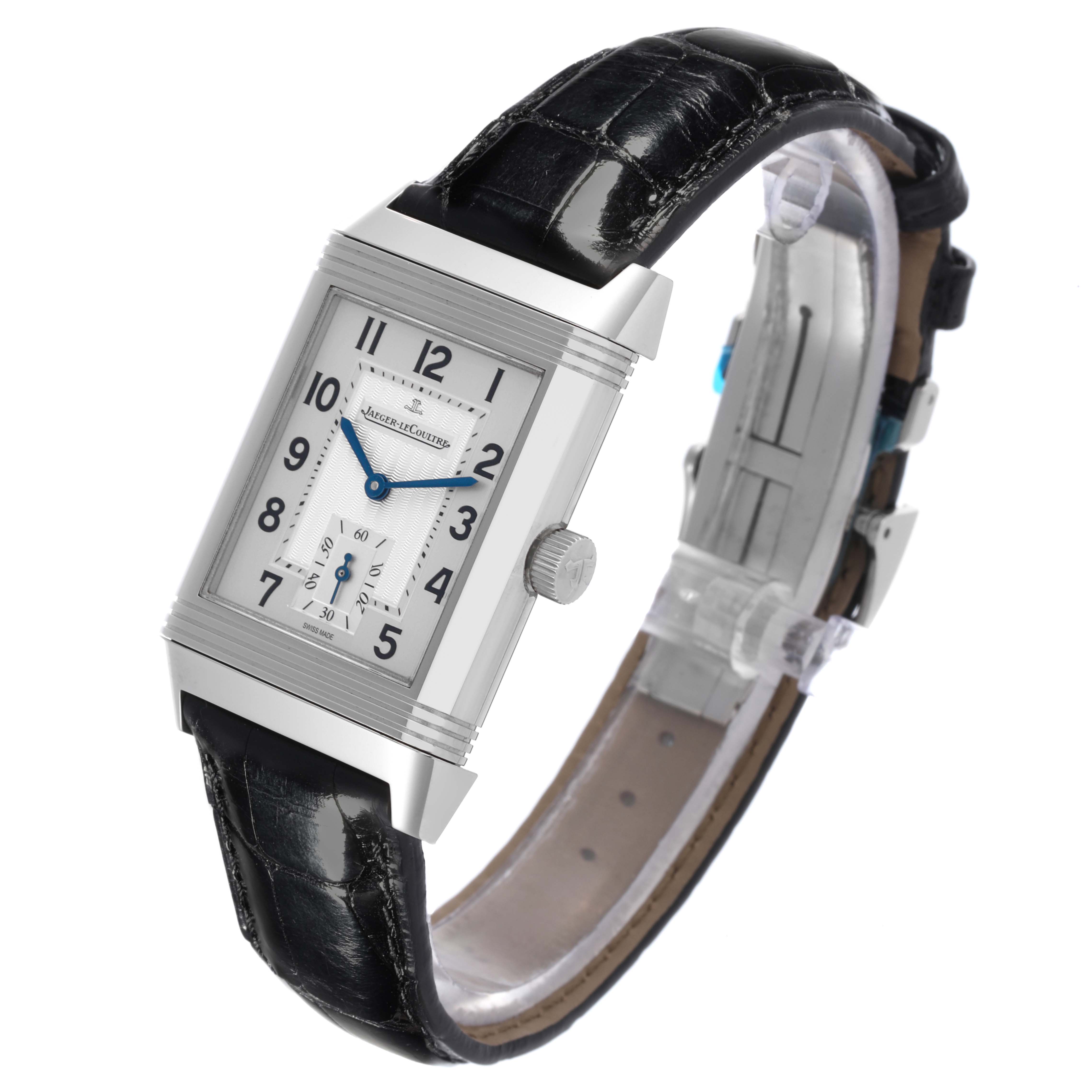 The Jaeger-LeCoultre Reverso watch is shown at a side angle, displaying its rectangular case, dial, crown, and leather strap.