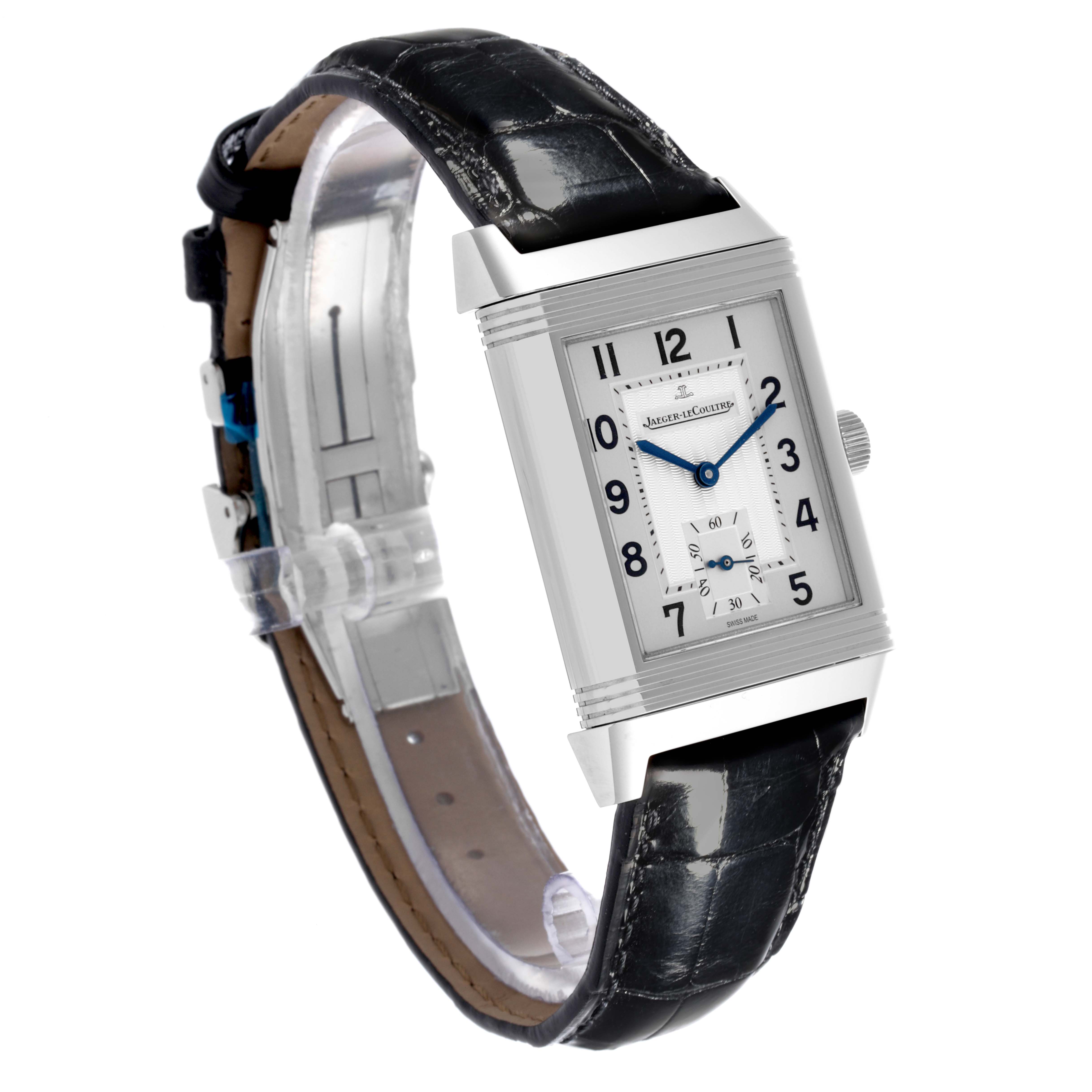 The Jaeger-LeCoultre Reverso watch is shown at a slight angle, displaying its rectangular dial and black leather strap.