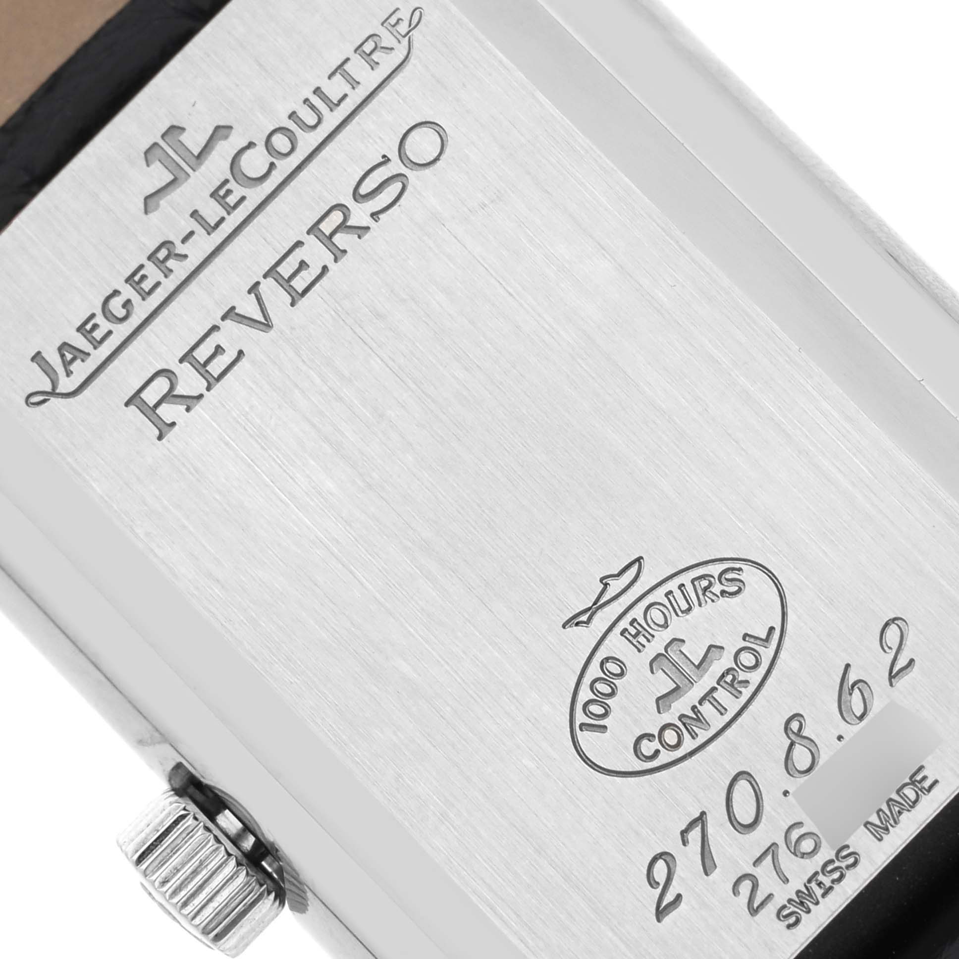 The image shows the back of a Jaeger-LeCoultre Reverso watch, displaying branding and control markings.