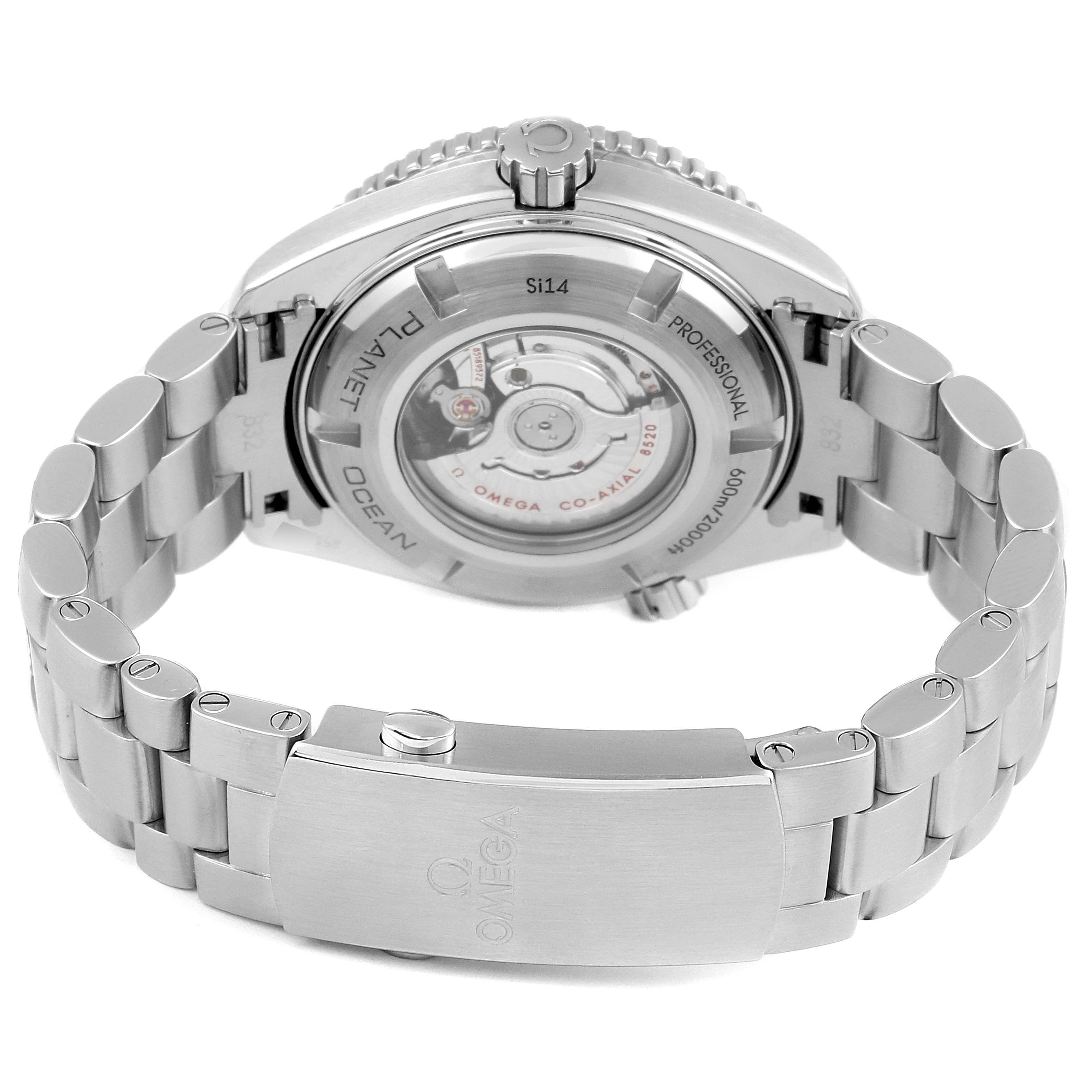 The image shows the back view of an Omega Planet Ocean 232.30.38.20.01.001  Men
s Stainless Steel Black Dial 232.30.38.20.01.001  Men
s Stainless Steel Black Dial watch, highlighting its transparent case back, metal bracelet, and clasp.