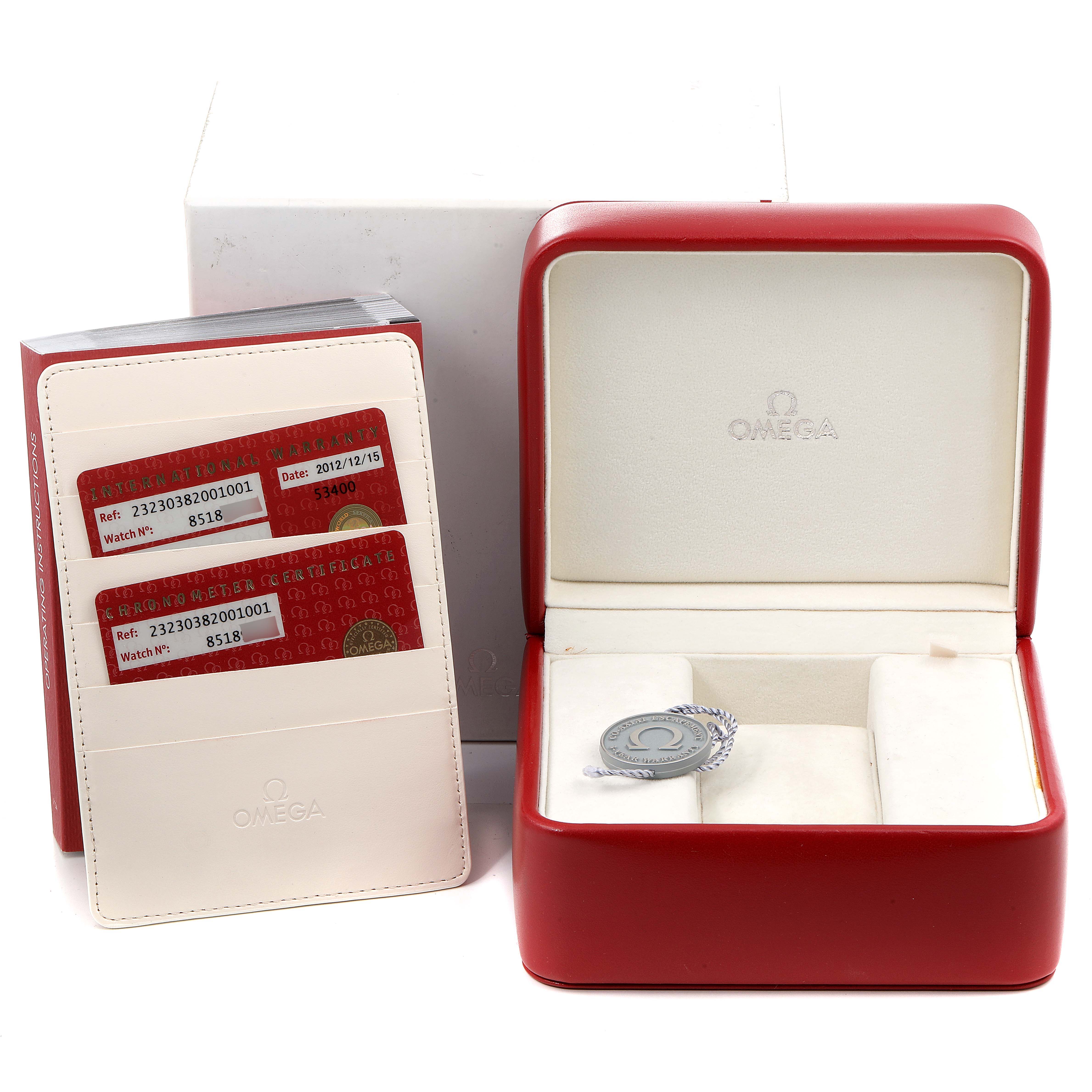 The image shows the Omega Planet Ocean 232.30.38.20.01.001  Men
s Stainless Steel Black Dial 232.30.38.20.01.001  Men
s Stainless Steel Black Dial
s accessories, including the watch box, certificate cards, and cardholder, from a frontal angle.