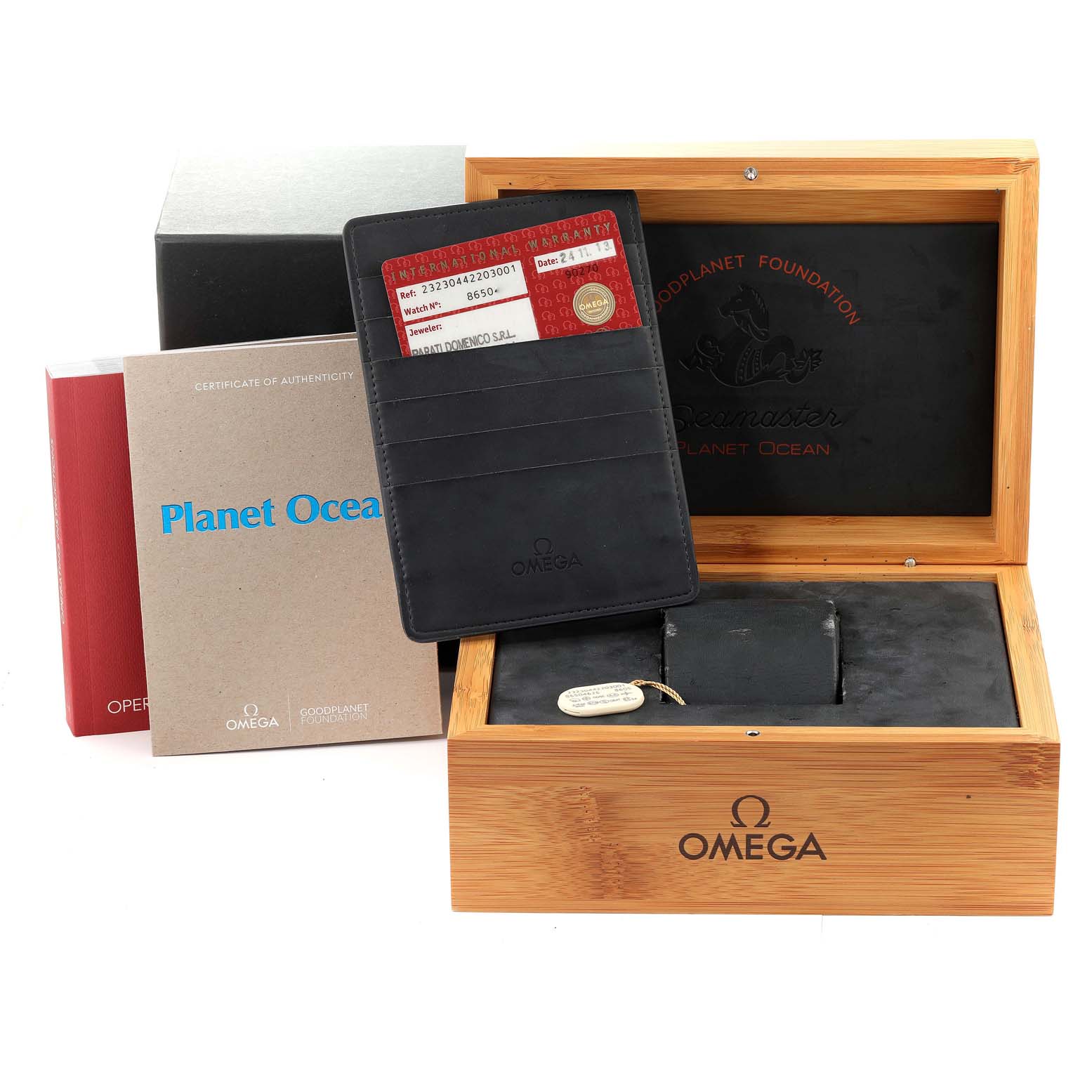 The image shows an Omega Planet Ocean 232.30.44.22.03.001 Men's Stainless Steel Blue Dial 232.30.44.22.03.001 Men's Stainless Steel Blue Dial watch box with authenticity cards and booklets displayed around it.