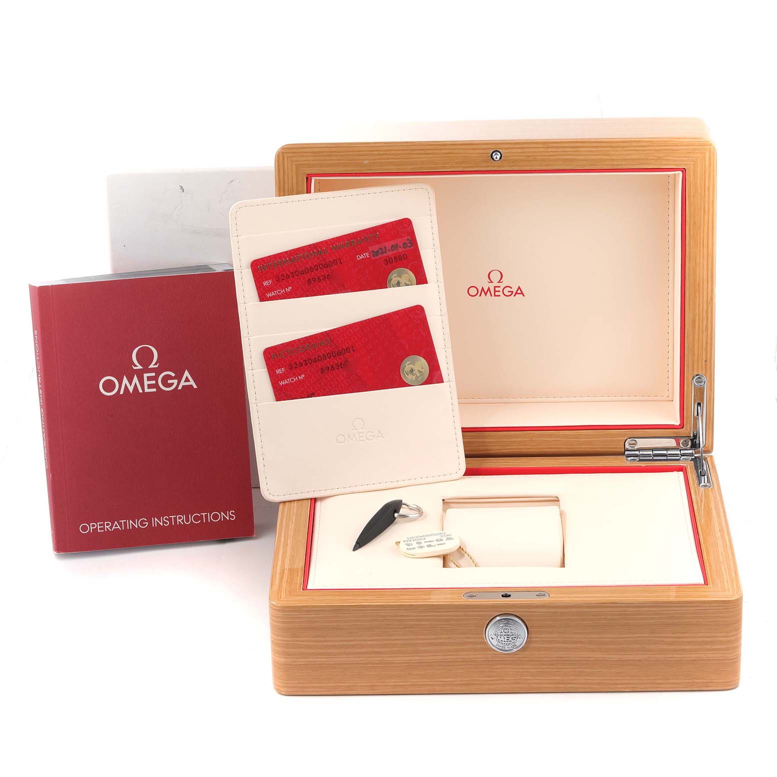 This image shows the box, operating instructions, and certification cards for the Omega Speedmaster 326.30.40.50.06.001 Men's Stainless Steel Grey Dial 326.30.40.50.06.001 Men's Stainless Steel Grey Dial watch.